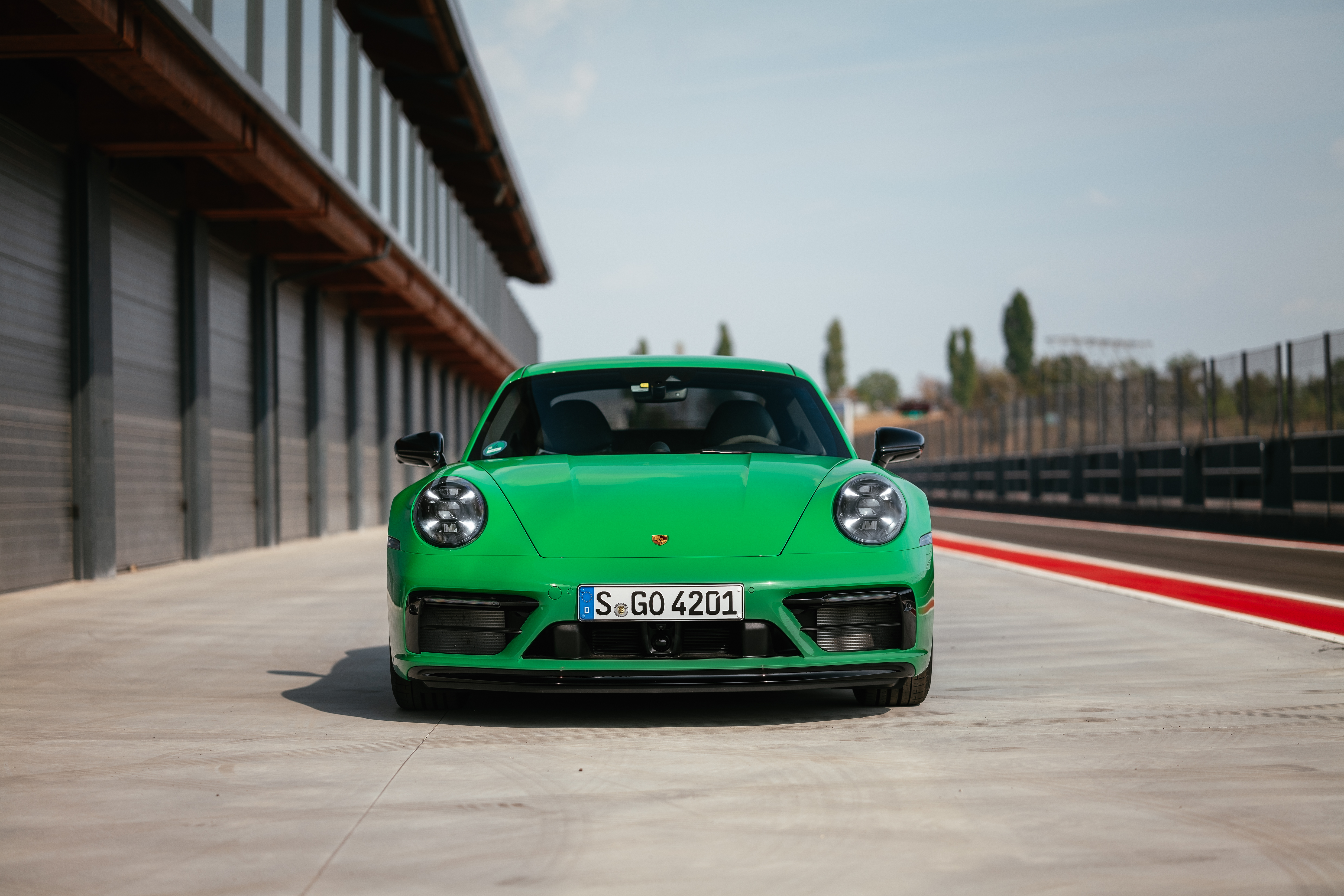 Green Porsche 911 Carrera GTS sport car on track HD Wallpaper