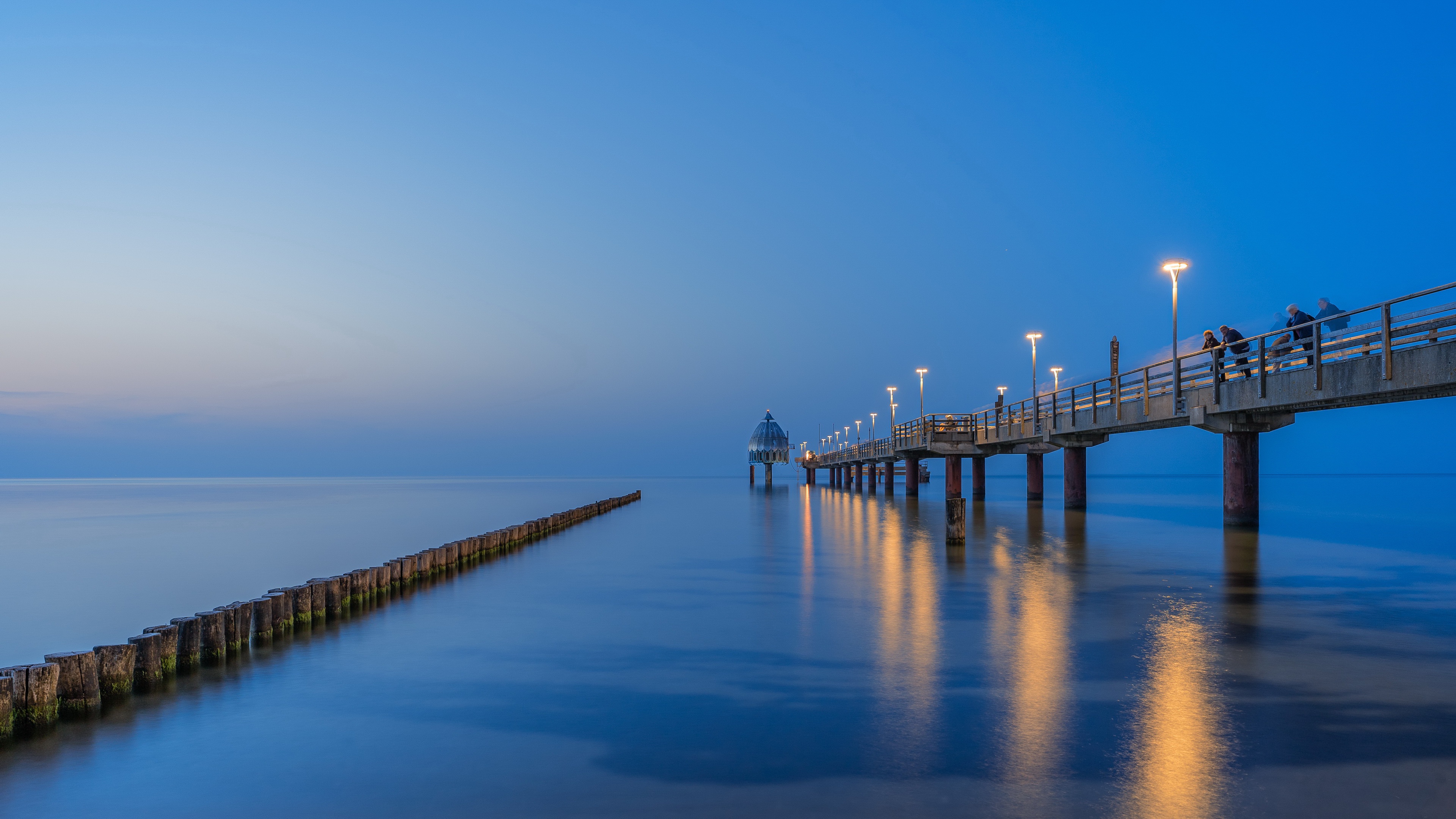 Illuminated Pier with Dome and Reflections at Twilight HD Wallpaper