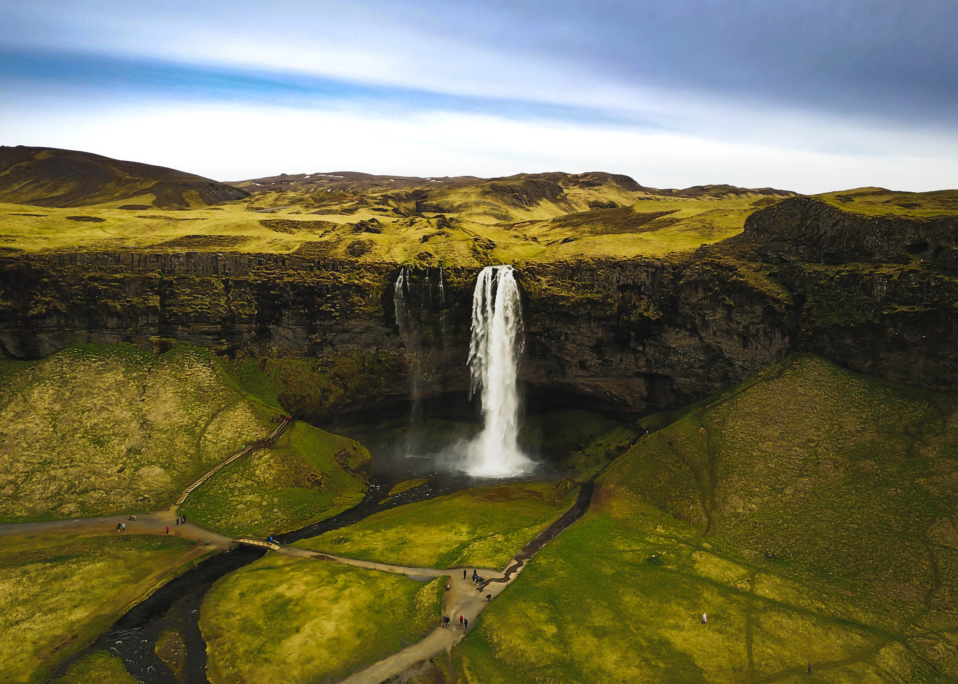 Seljalandsfoss Waterfall in a lush green landscape HD Wallpaper