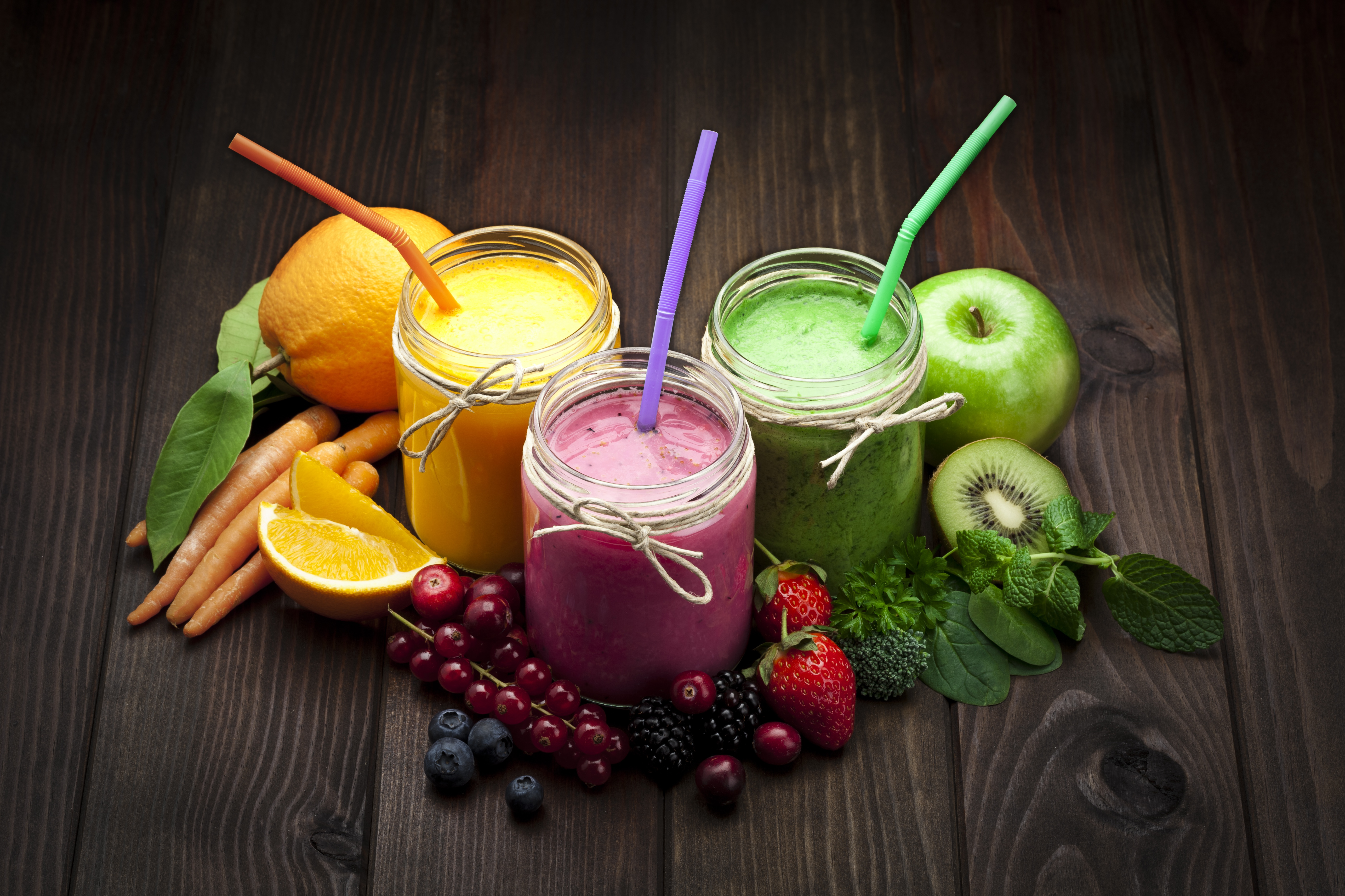 Colorful smoothies and fresh ingredients on dark wood 4K HD Wallpaper