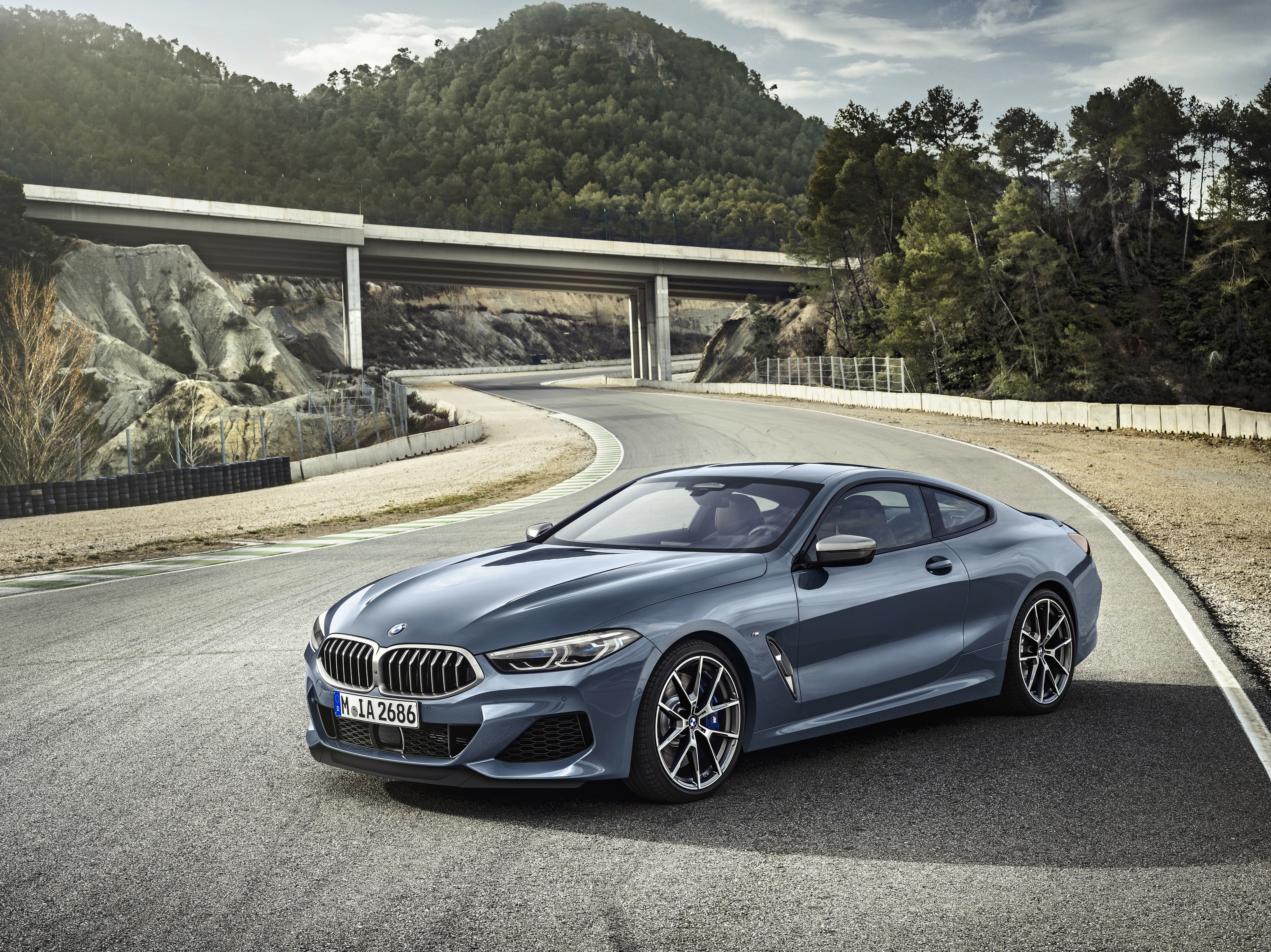 Blue BMW M850i Luxury Car on Winding Road 4K HD Wallpaper