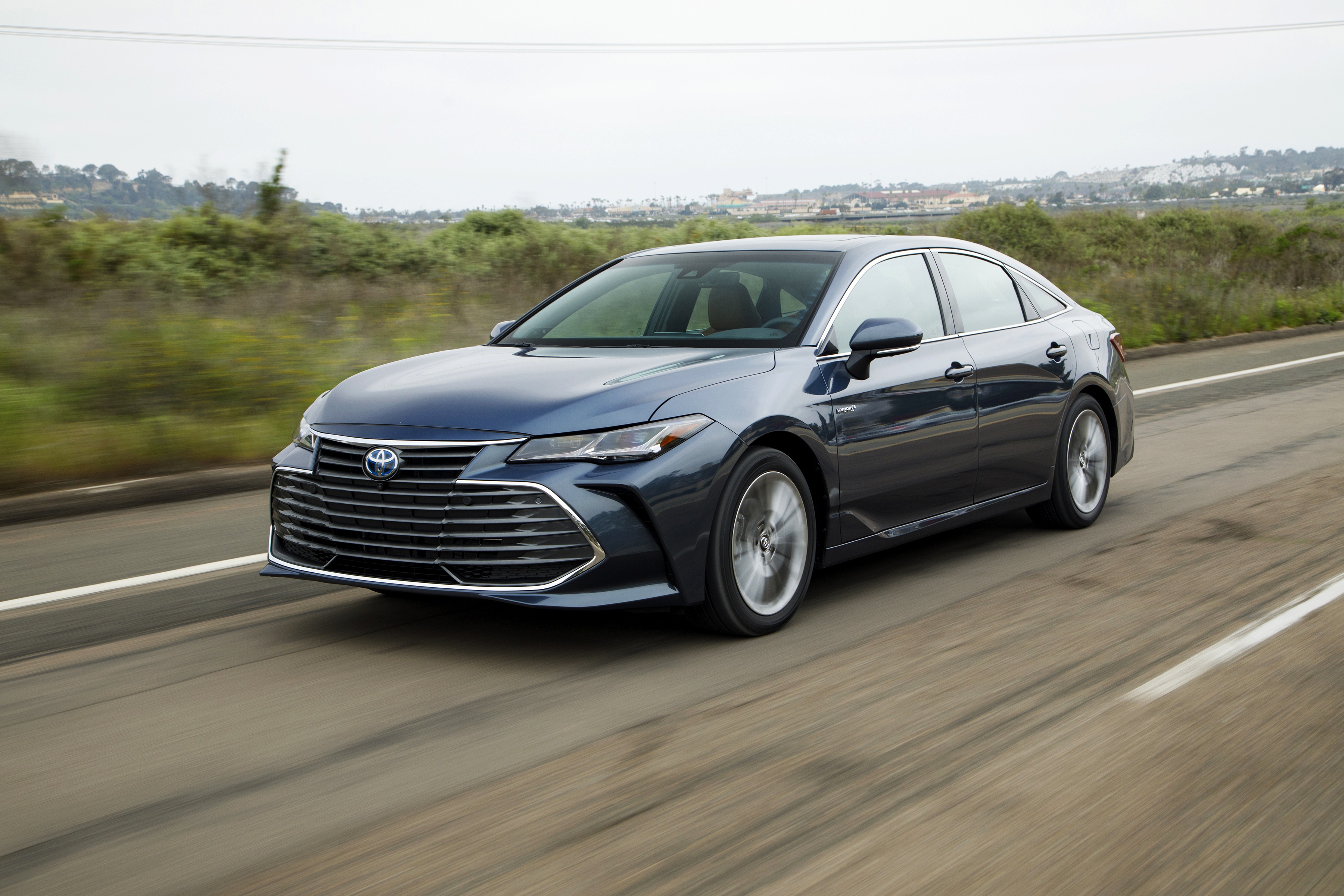 Blue Toyota Avalon driving on road HD Wallpaper