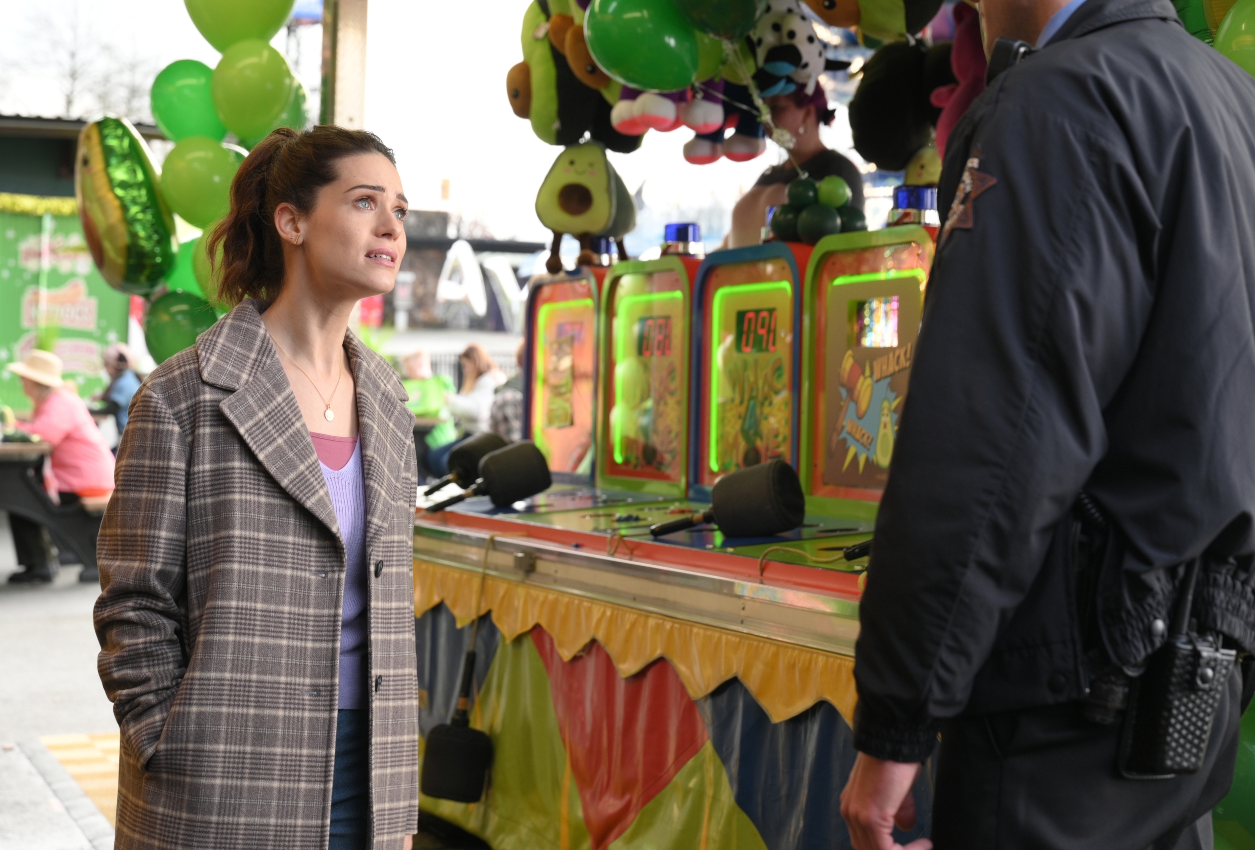 Lyndsy Fonseca looks concerned at carnival game booth HD Wallpaper