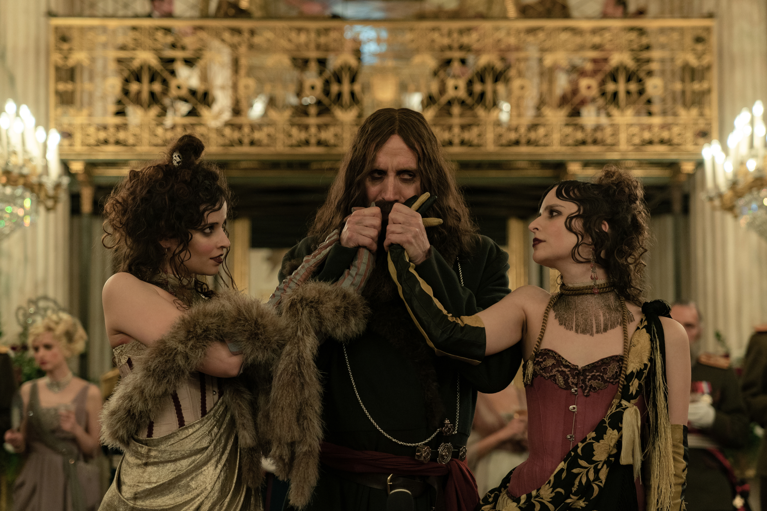Rhys Ifans as Rasputin with two women in The King's Man HD Wallpaper