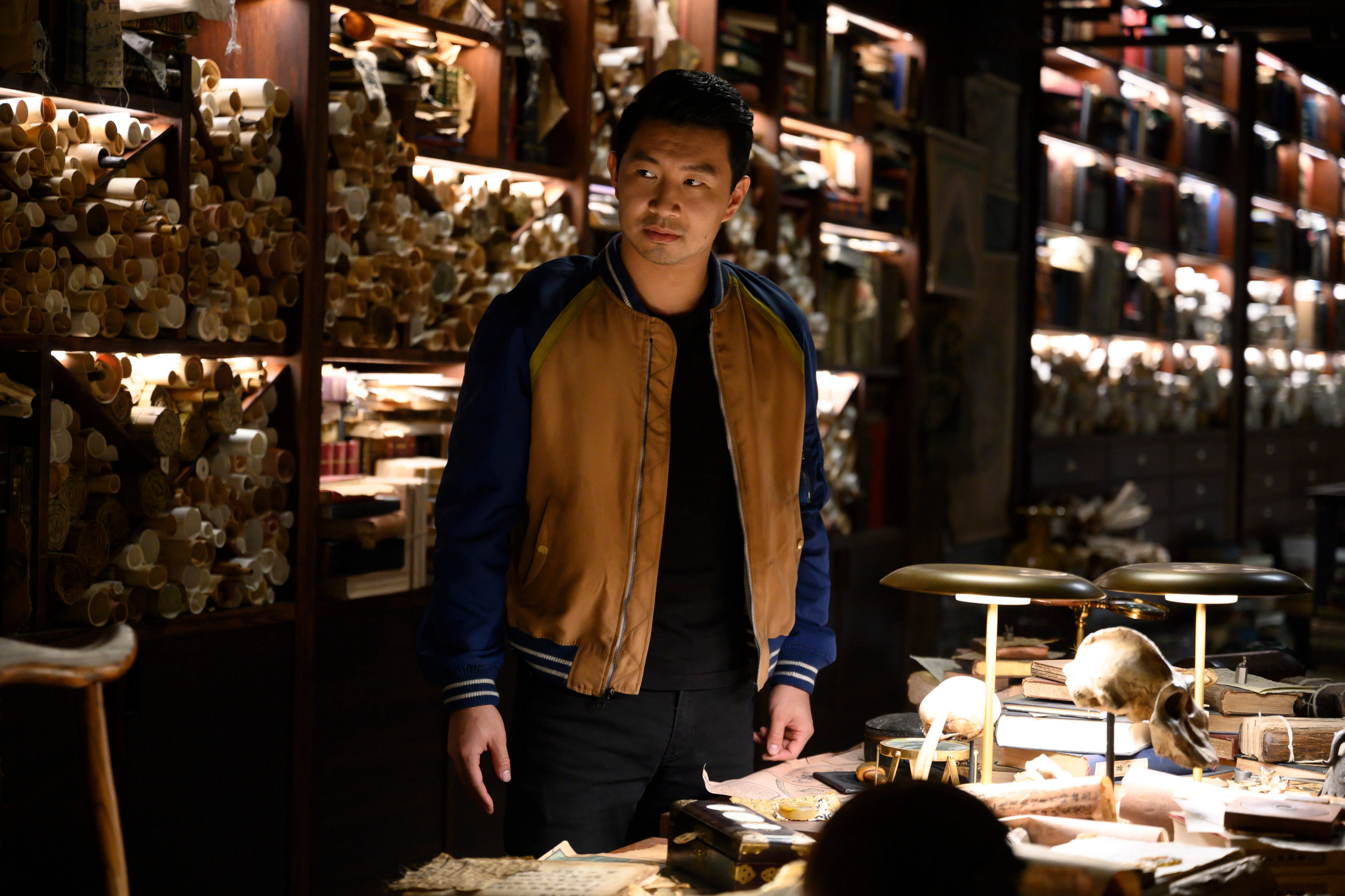 Simu Liu as Shang-Chi in a mysterious library HD Wallpaper
