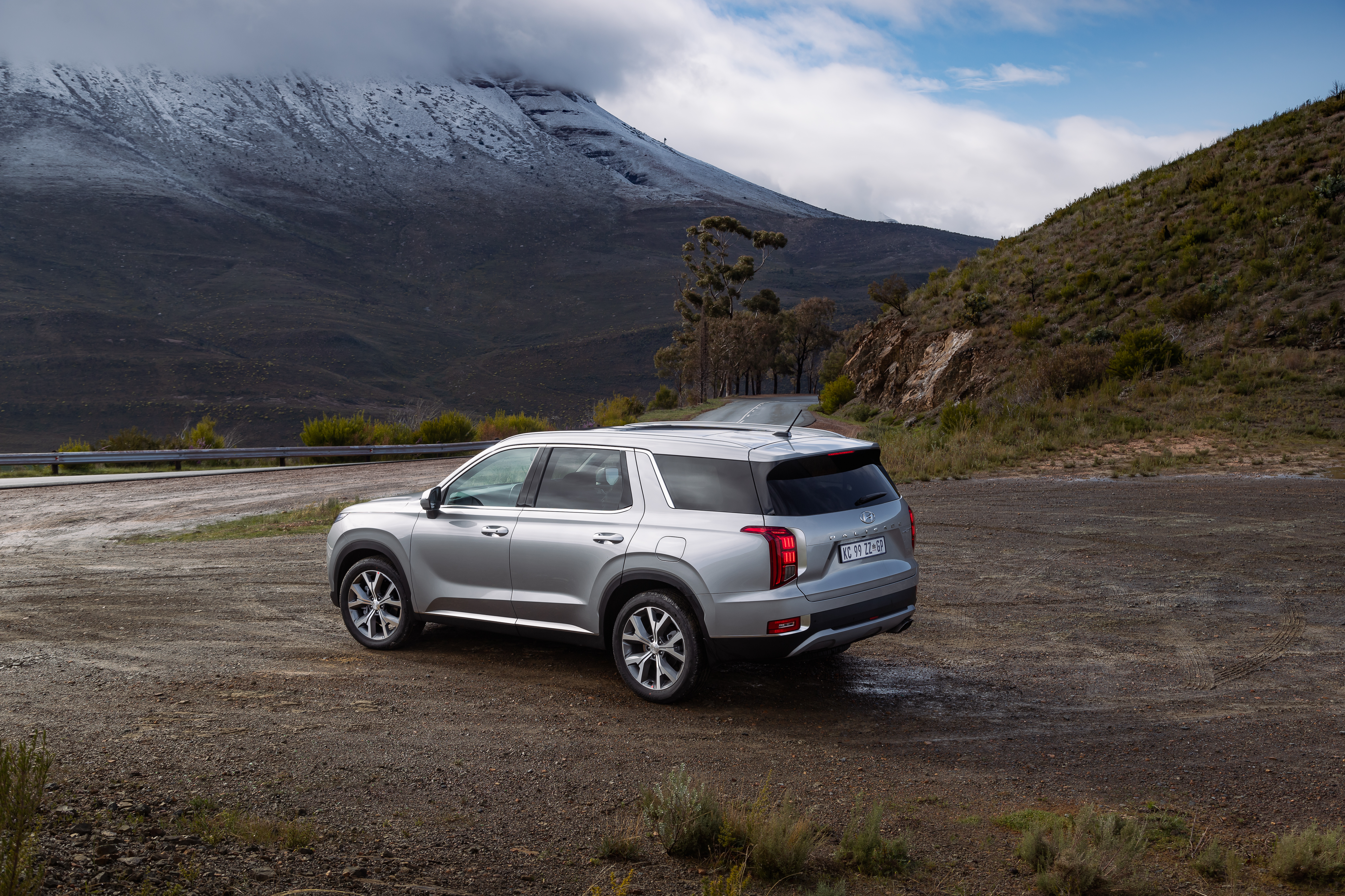 Silver Hyundai Palisade SUV with snowy mountains HD Wallpaper