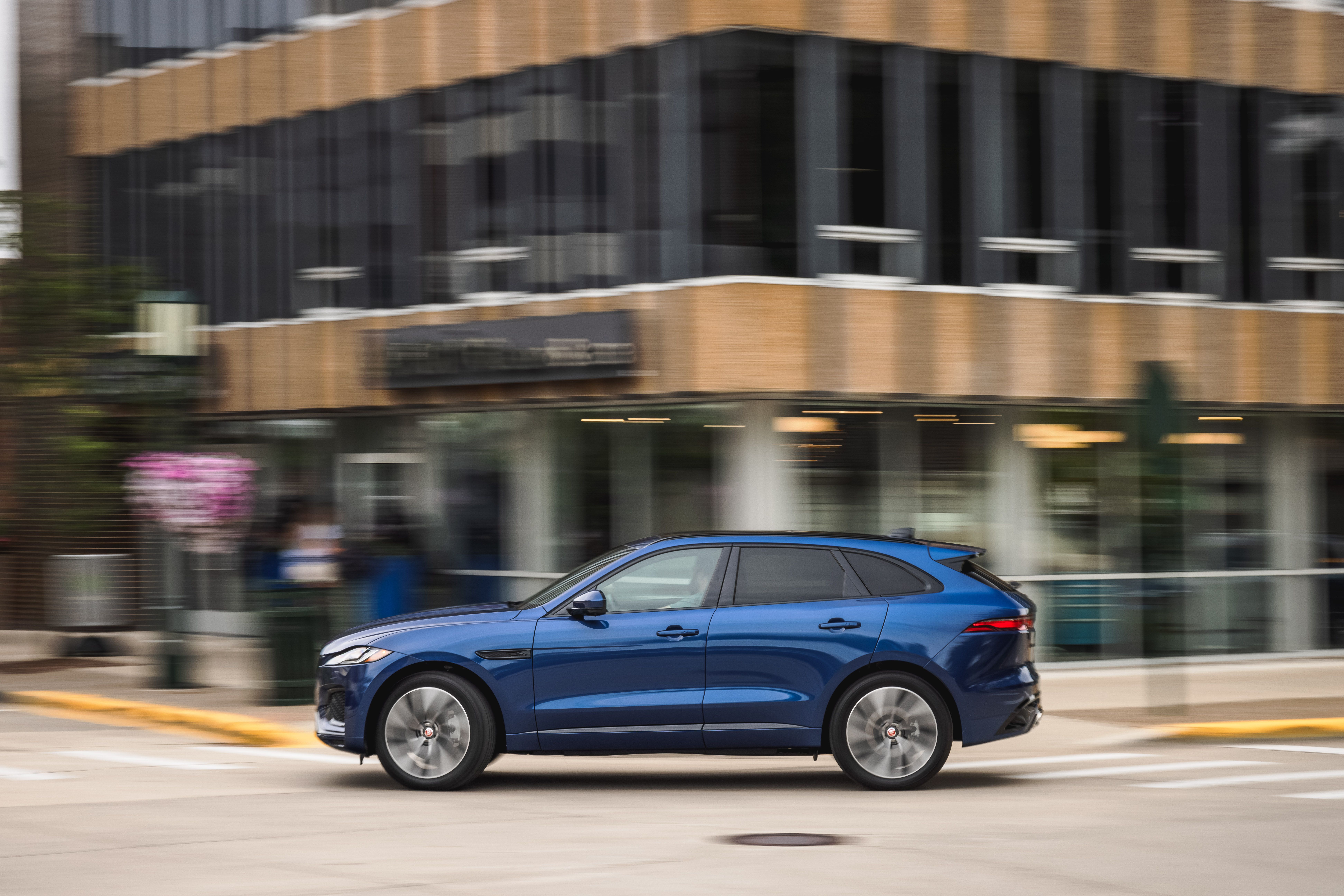 Blue Jaguar F-Pace SUV driving in city HD Wallpaper