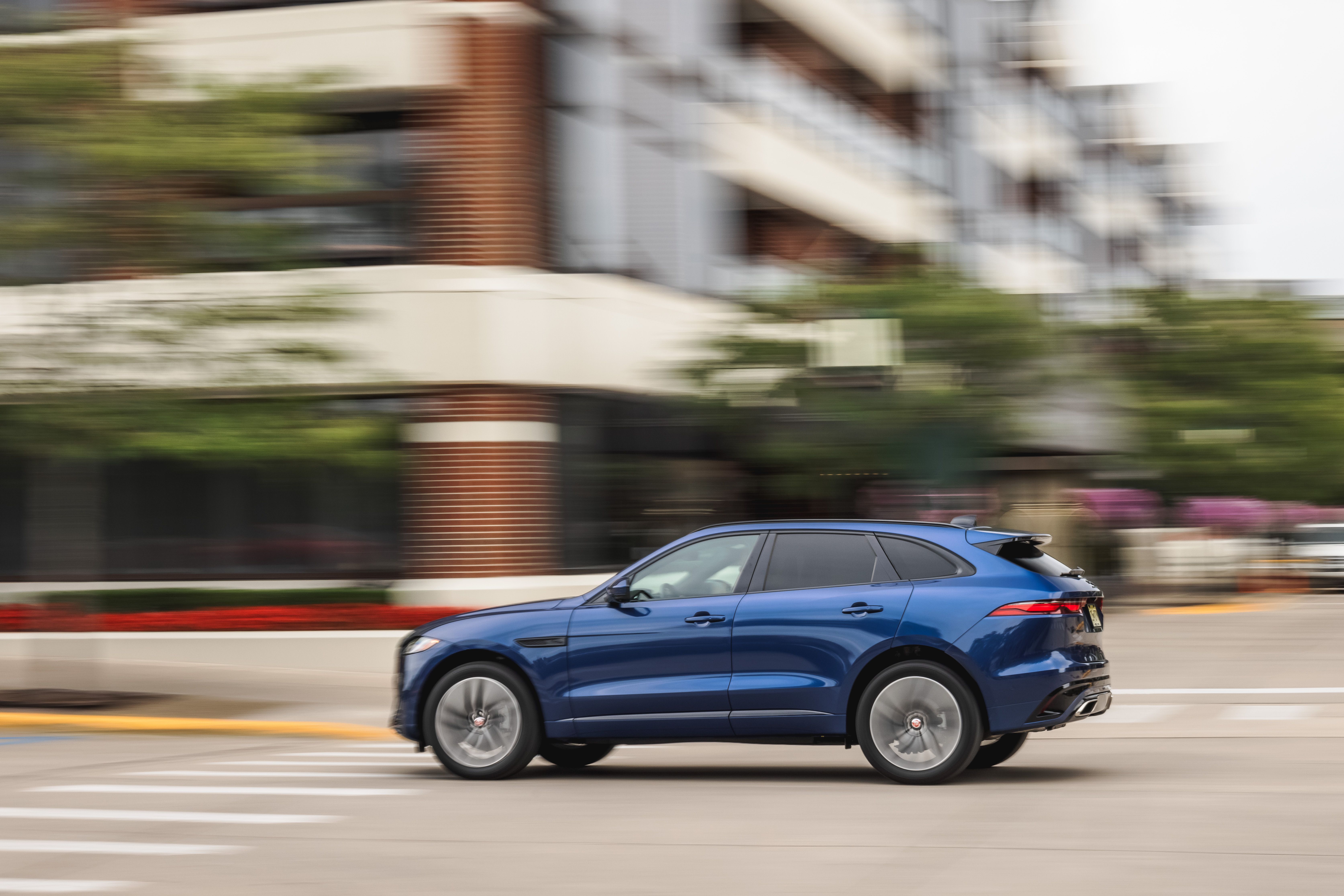 Blue Jaguar F-Pace SUV driving on street HD Wallpaper