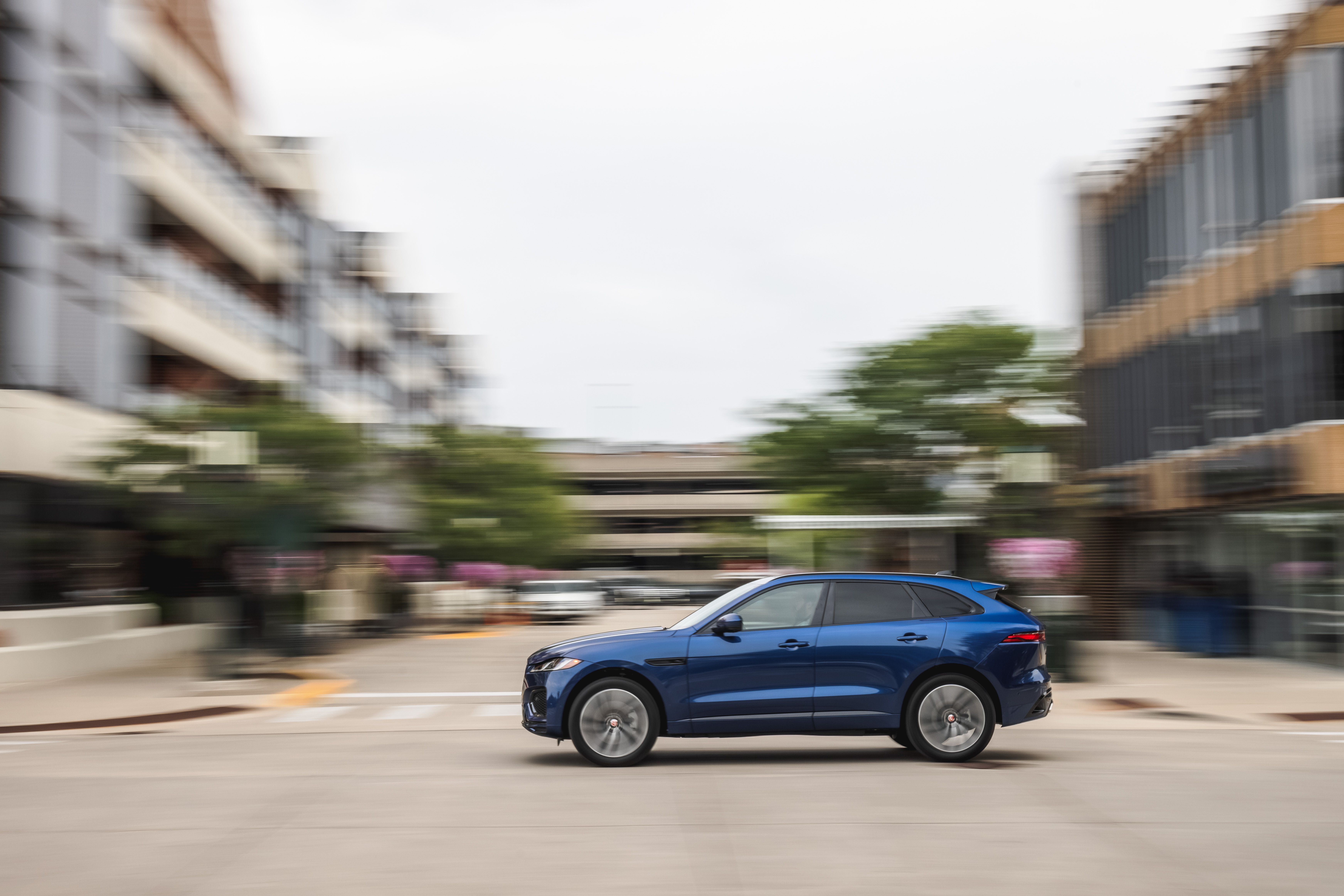 Blue Jaguar F-Pace SUV driving HD Wallpaper