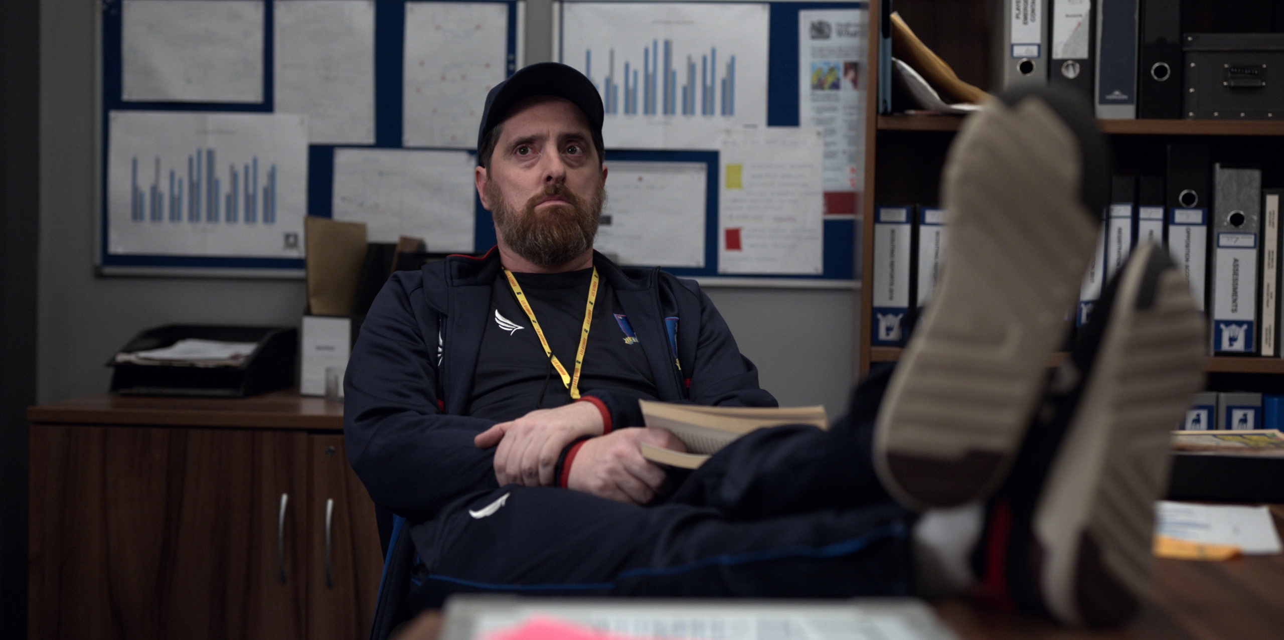 Brendan Hunt as Coach Beard relaxing in office HD Wallpaper