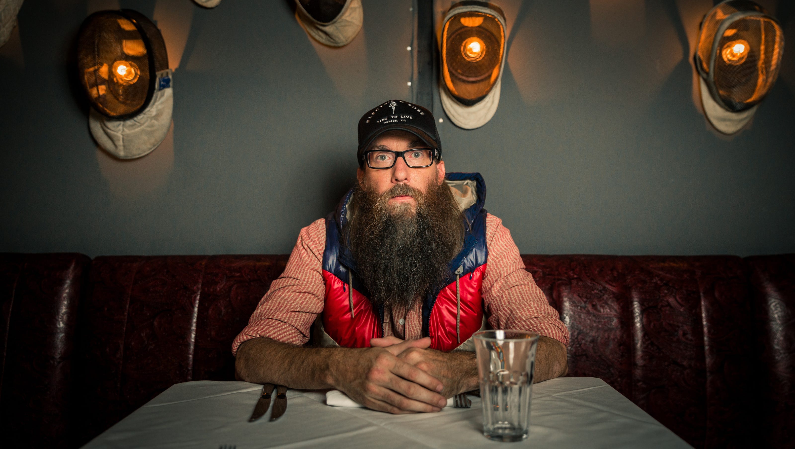 Crowder with a long beard in a restaurant booth HD Wallpaper
