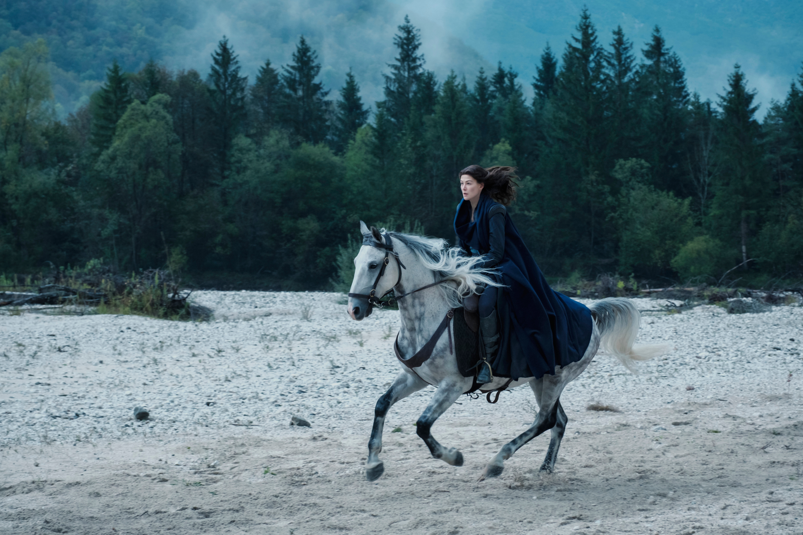 Rosamund Pike riding a white horse in The Wheel of Time HD Wallpaper