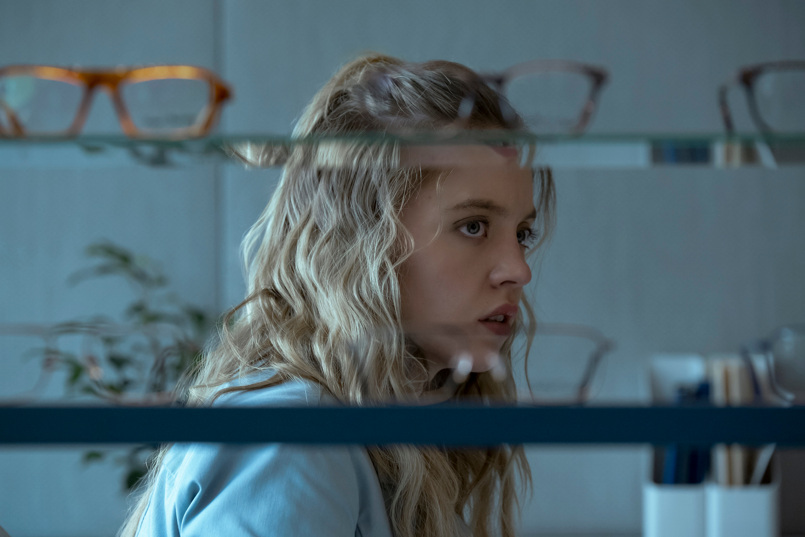 Sydney Sweeney looking at glasses HD Wallpaper