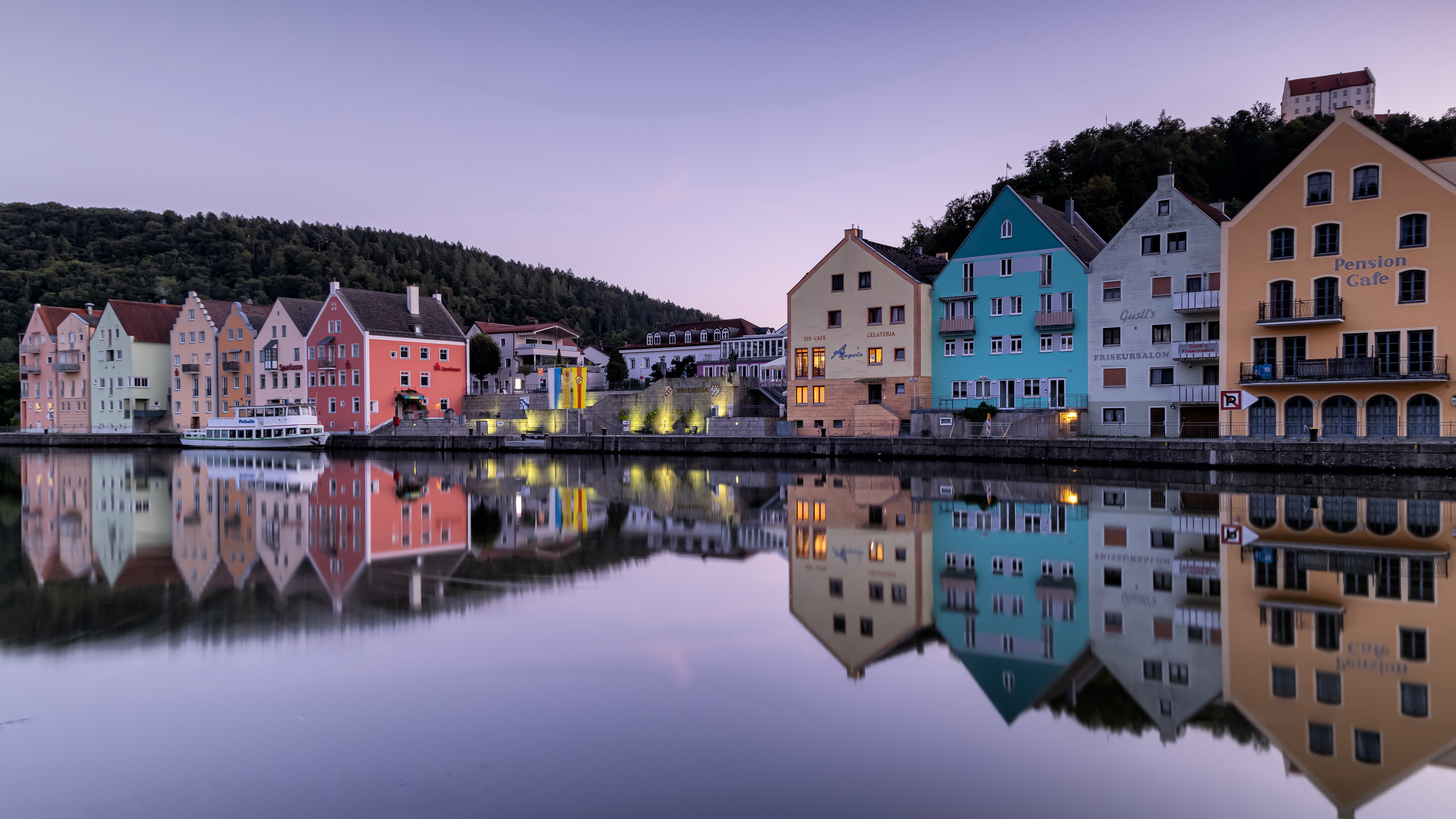 Colorful Riedenburg buildings reflected in water at dusk HD Wallpaper