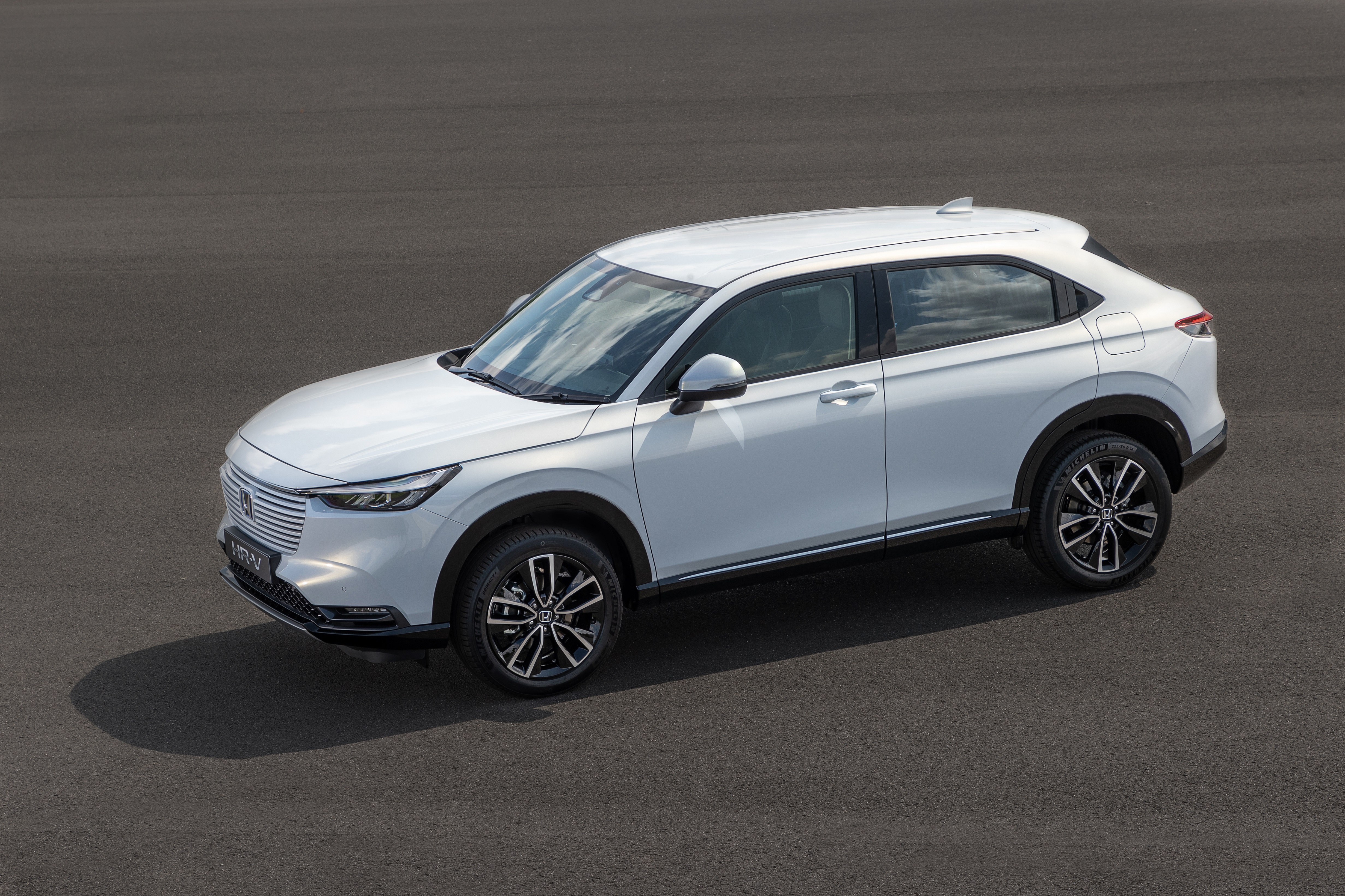 White Honda HR-V e:HEV SUV on asphalt HD Wallpaper