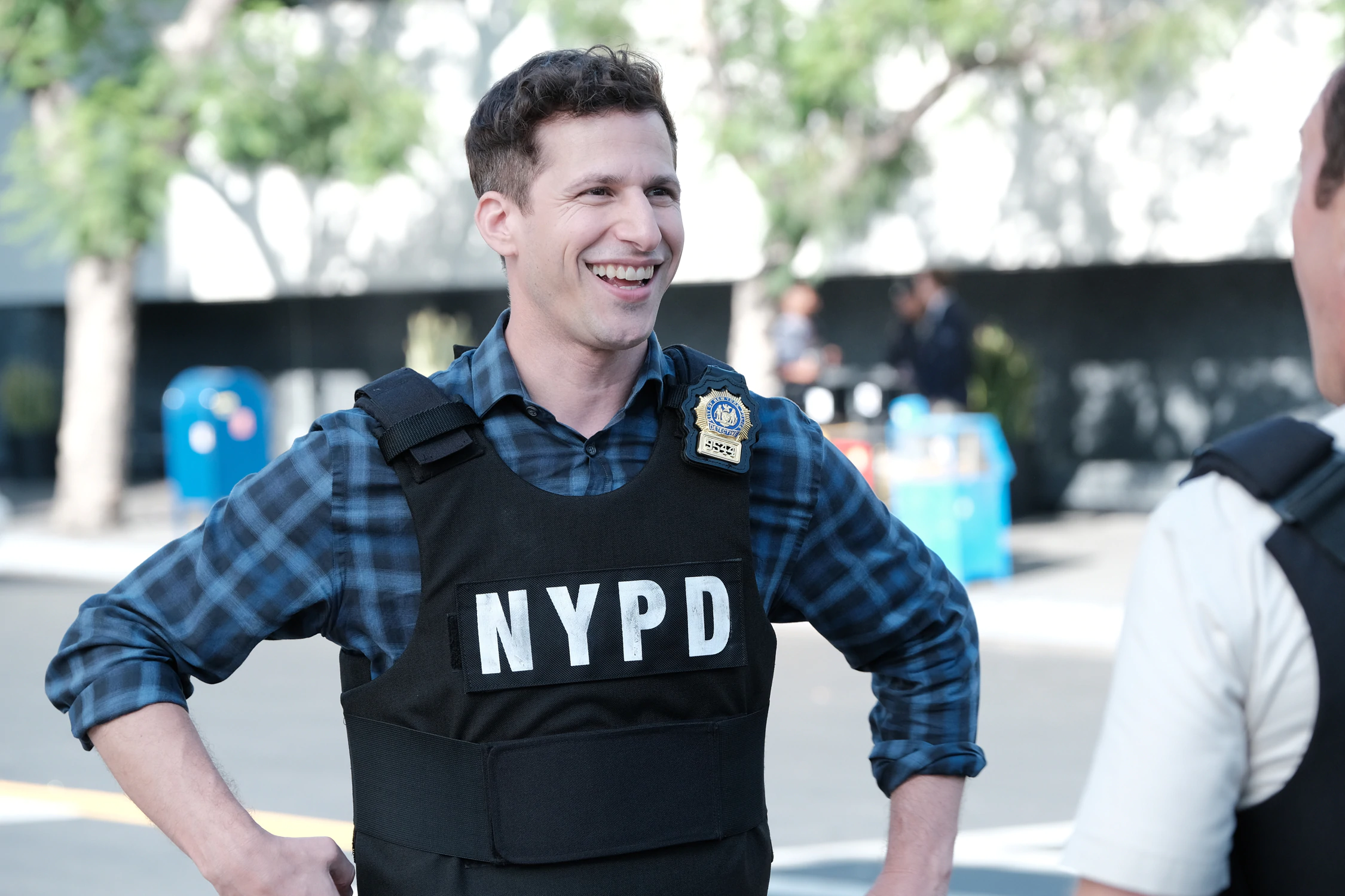 Andy Samberg as Jake Peralta smiling in NYPD vest HD Wallpaper
