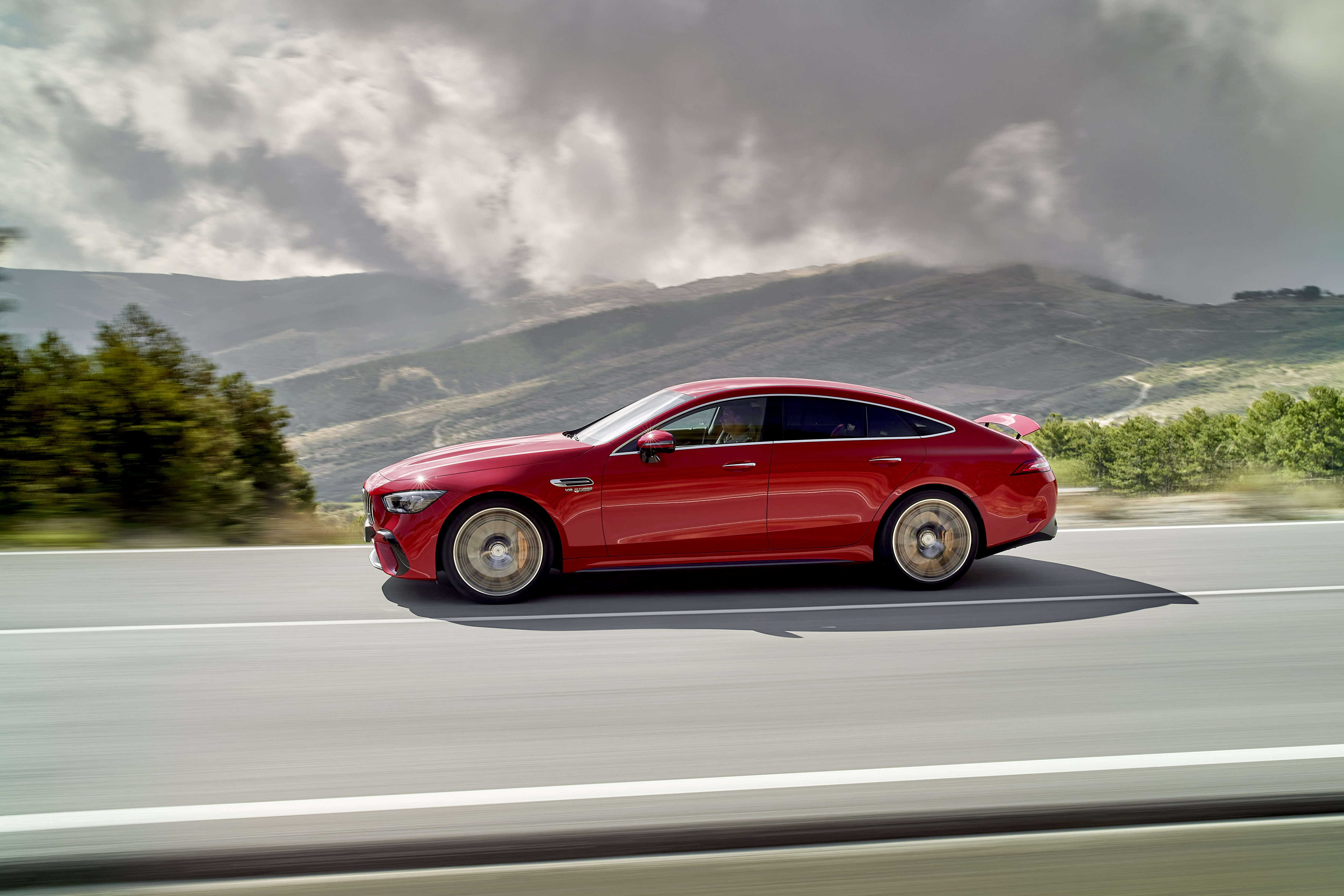 Red Mercedes-AMG GT 63 S E Performance driving through mountains HD Wallpaper