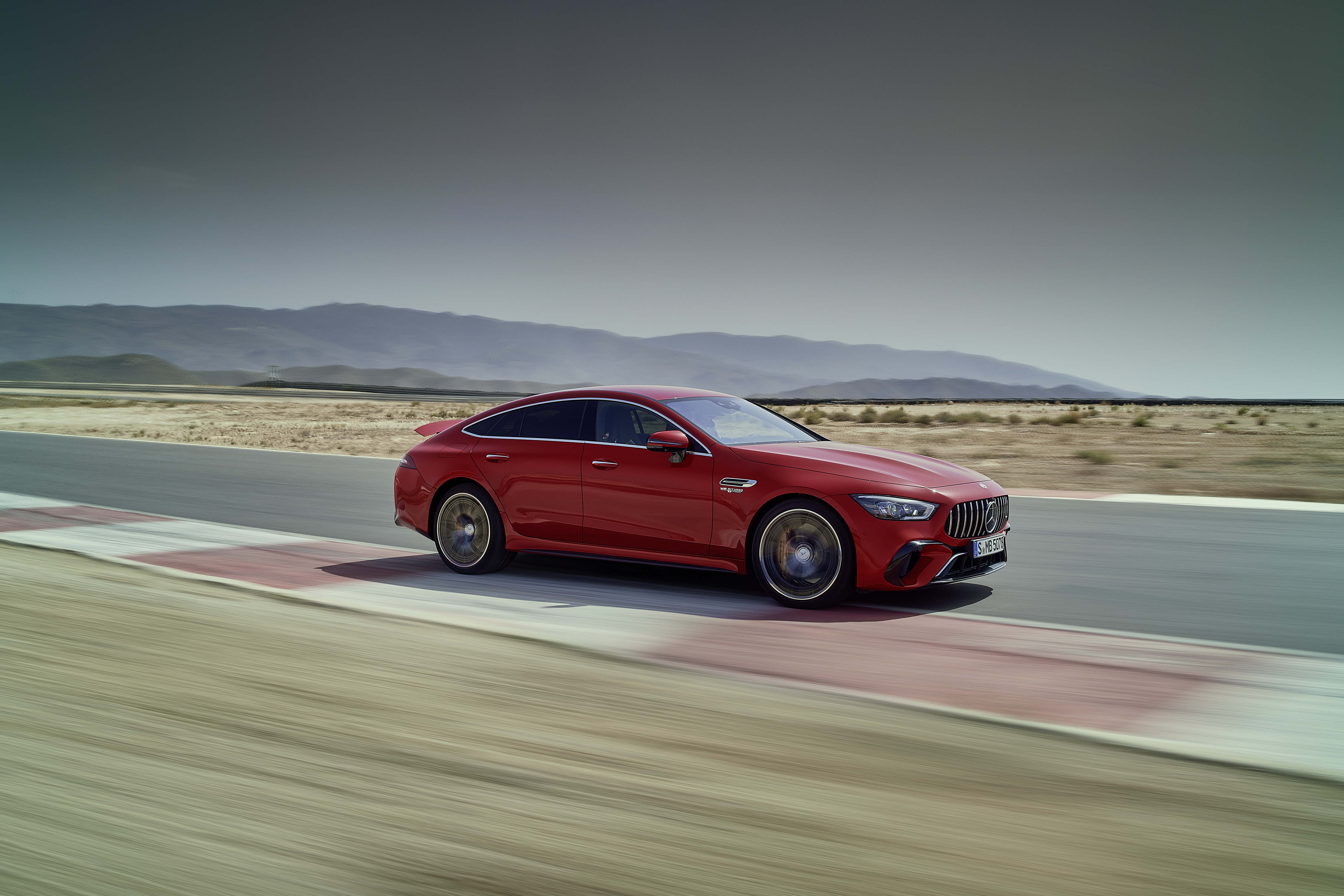 Red Mercedes-AMG GT 63 S E Performance driving on track HD Wallpaper
