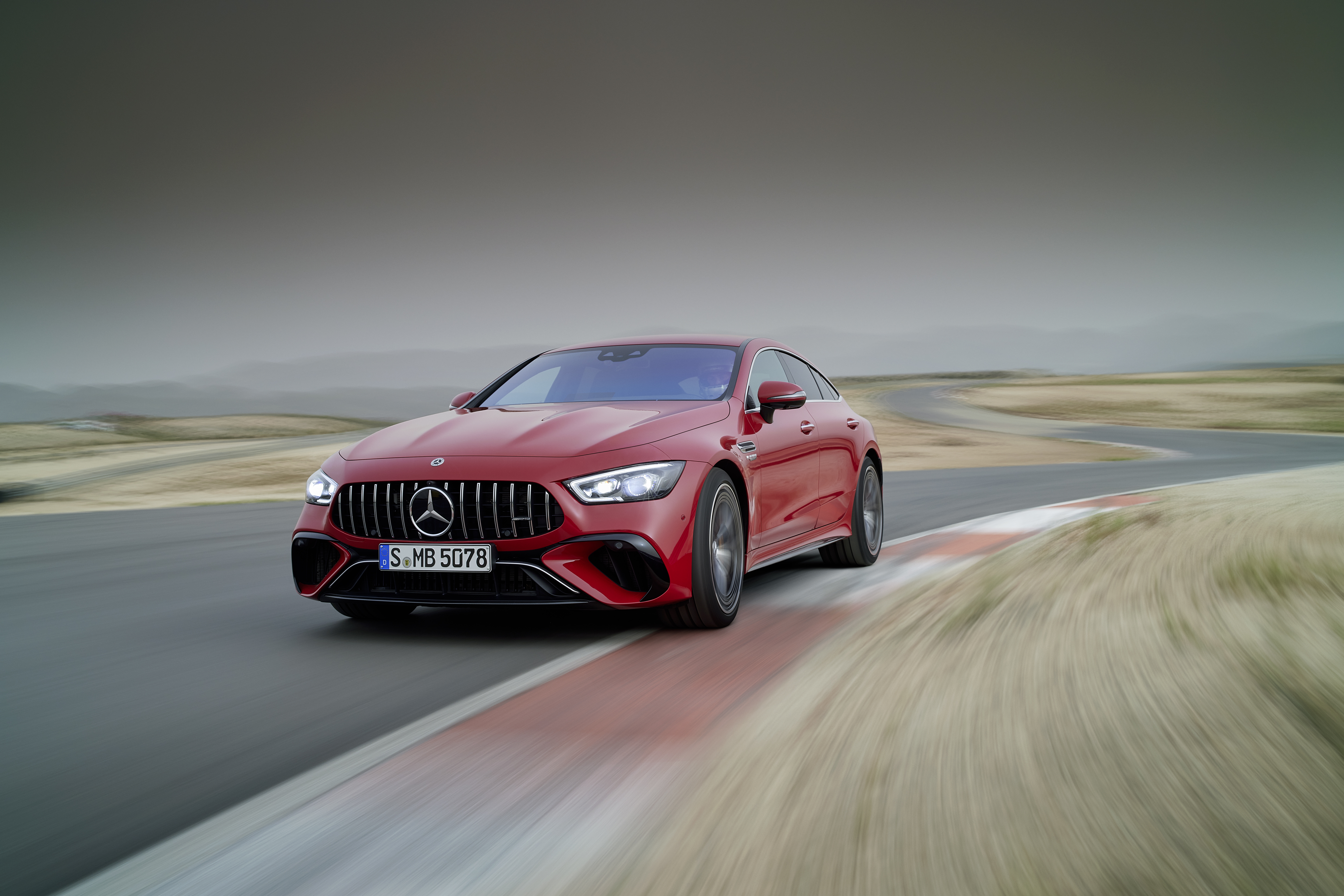 Red Mercedes-AMG GT 63 S E Performance speeding on track HD Wallpaper