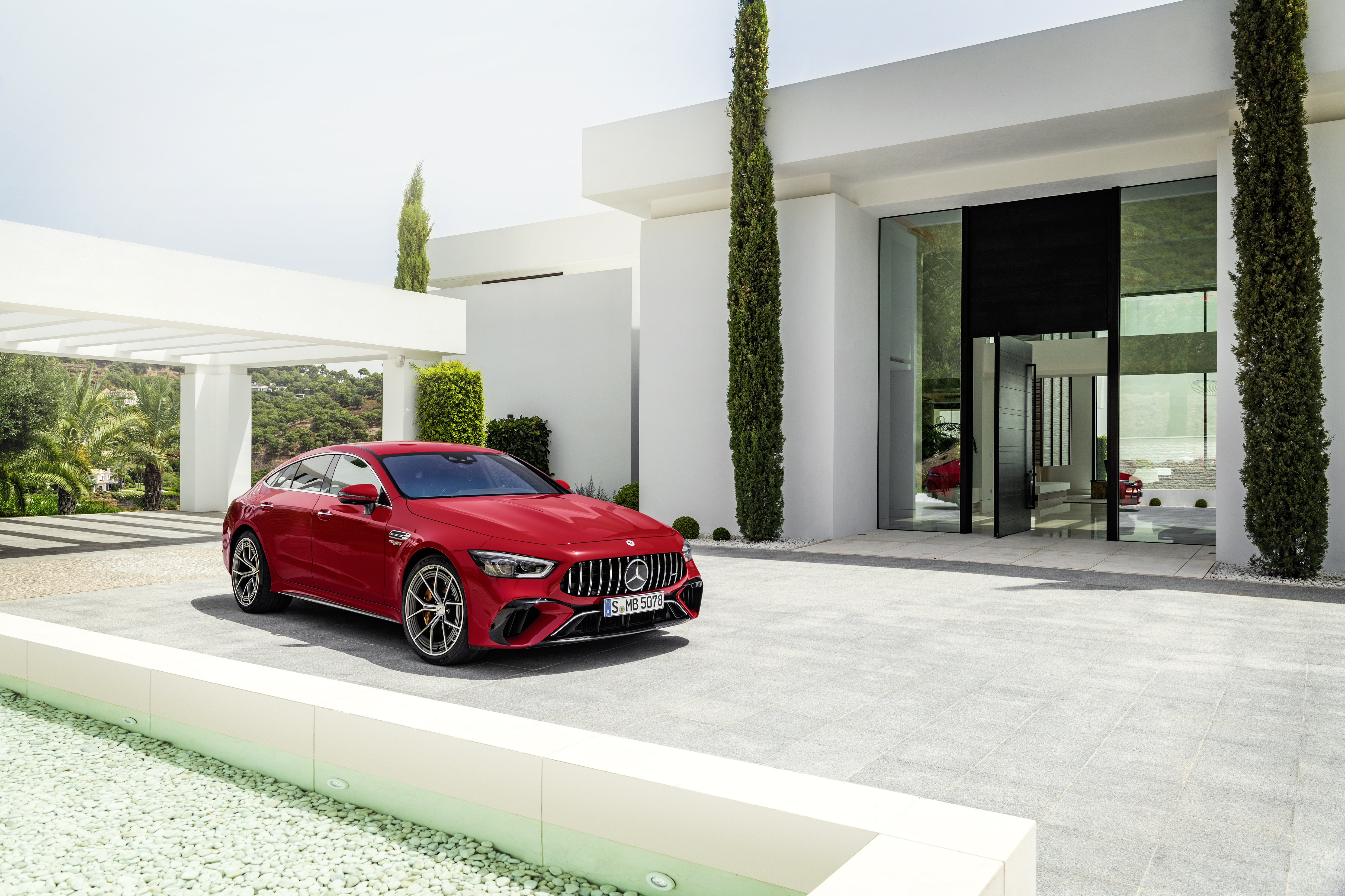 Red Mercedes-AMG GT 63 S E Performance at a luxury home HD Wallpaper