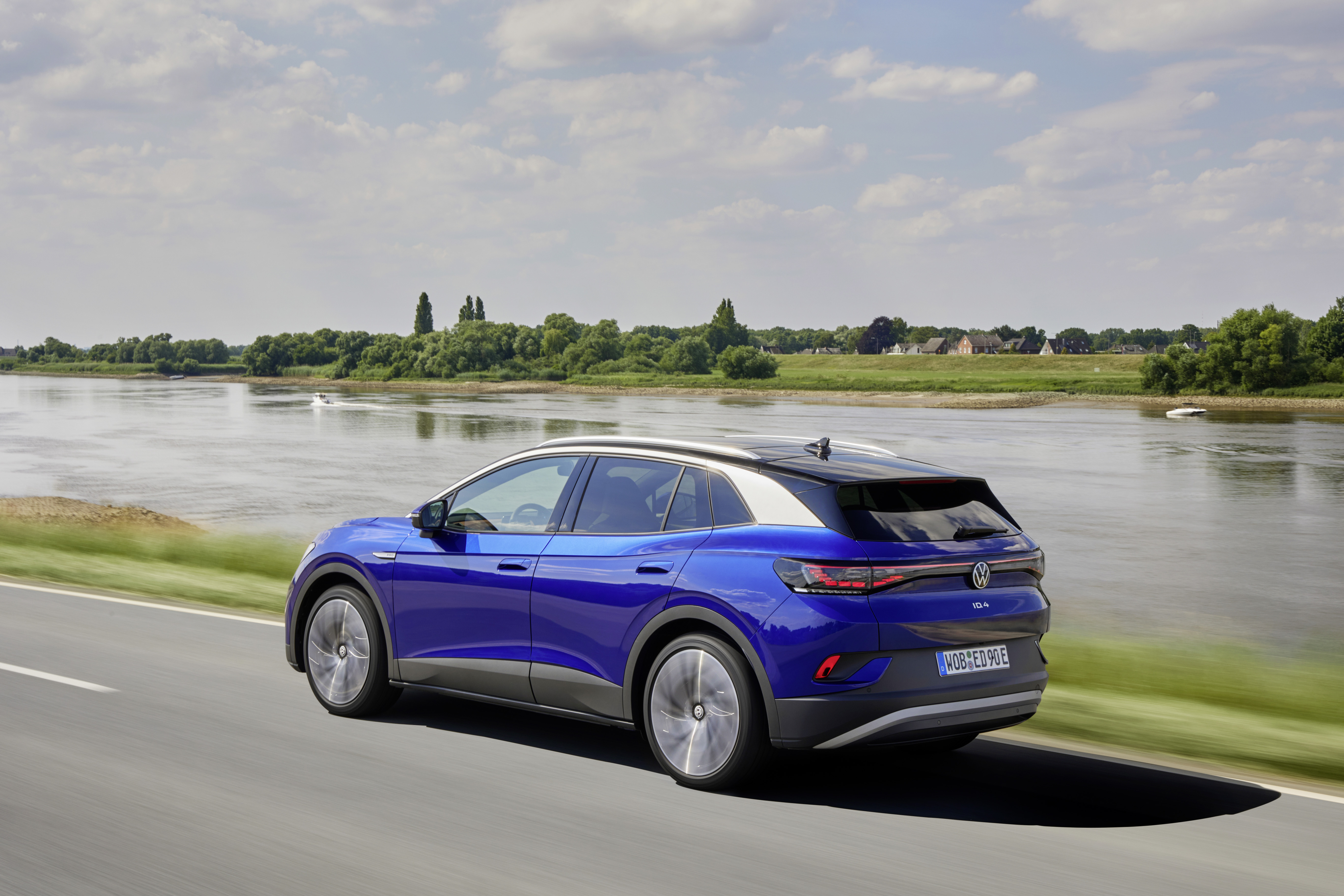 Blue Volkswagen ID.4 Electric Car Driving by River HD Wallpaper