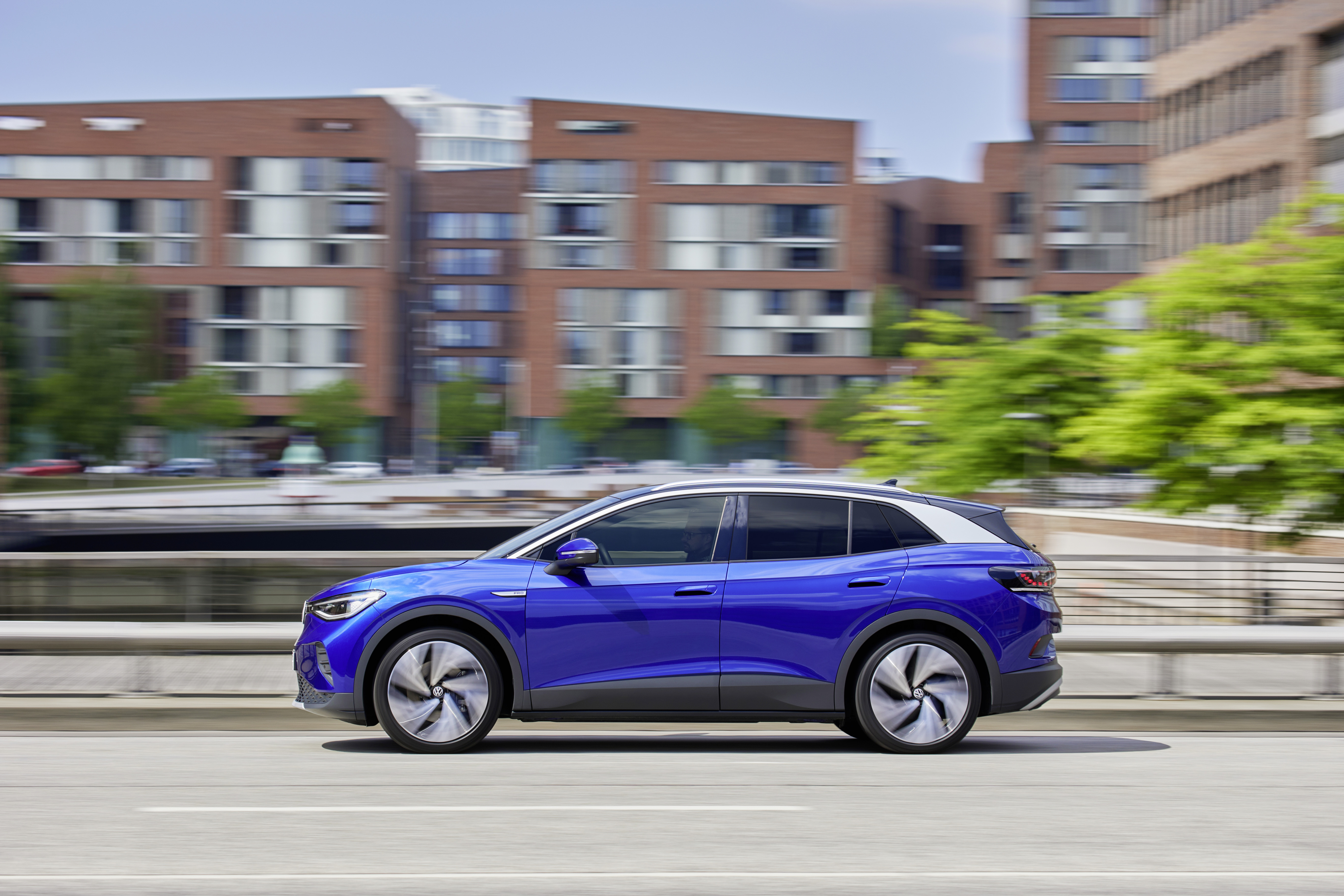 Volkswagen ID.4 Pro electric car driving in city HD Wallpaper