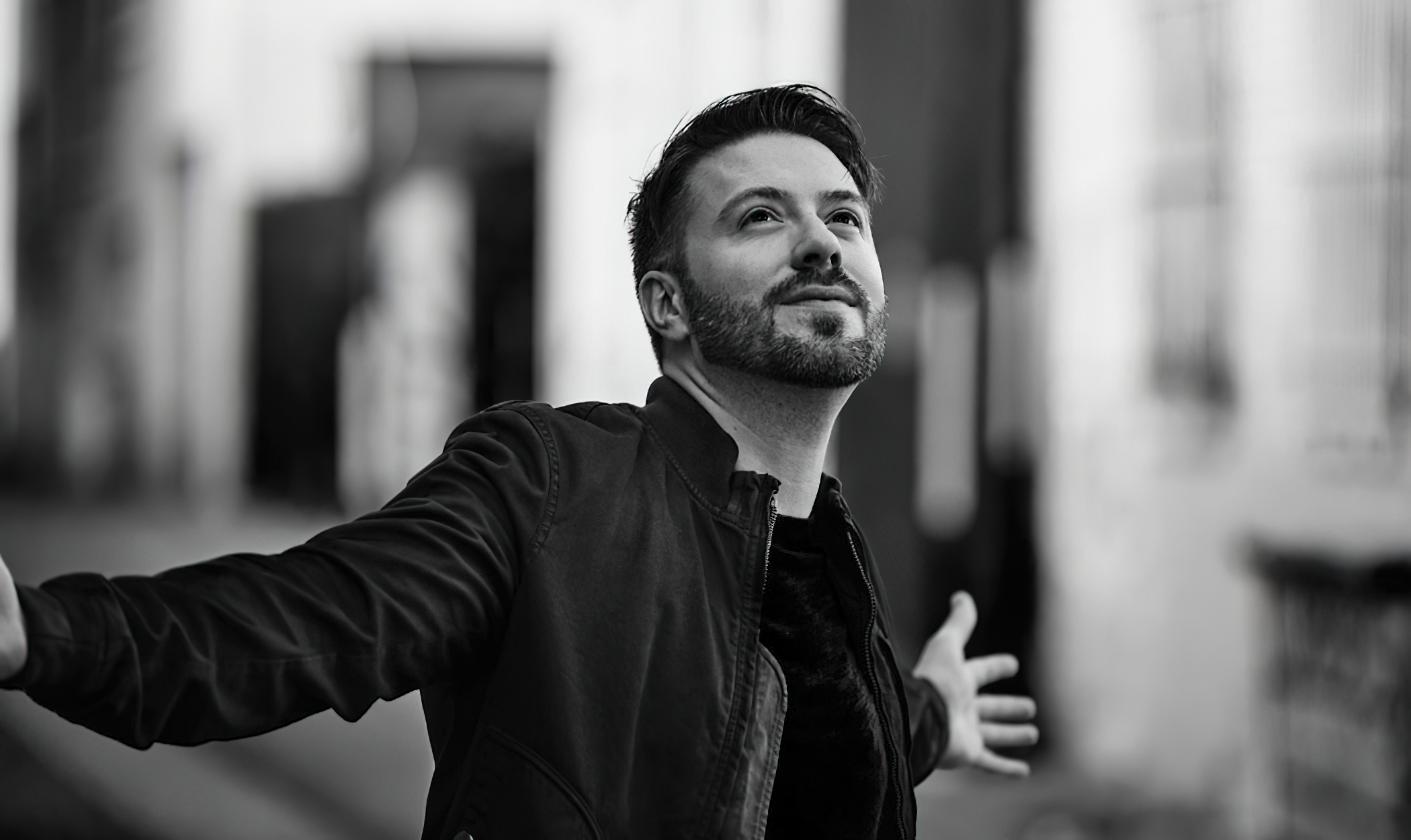 Joyful Danny Gokey with arms open wide HD Wallpaper