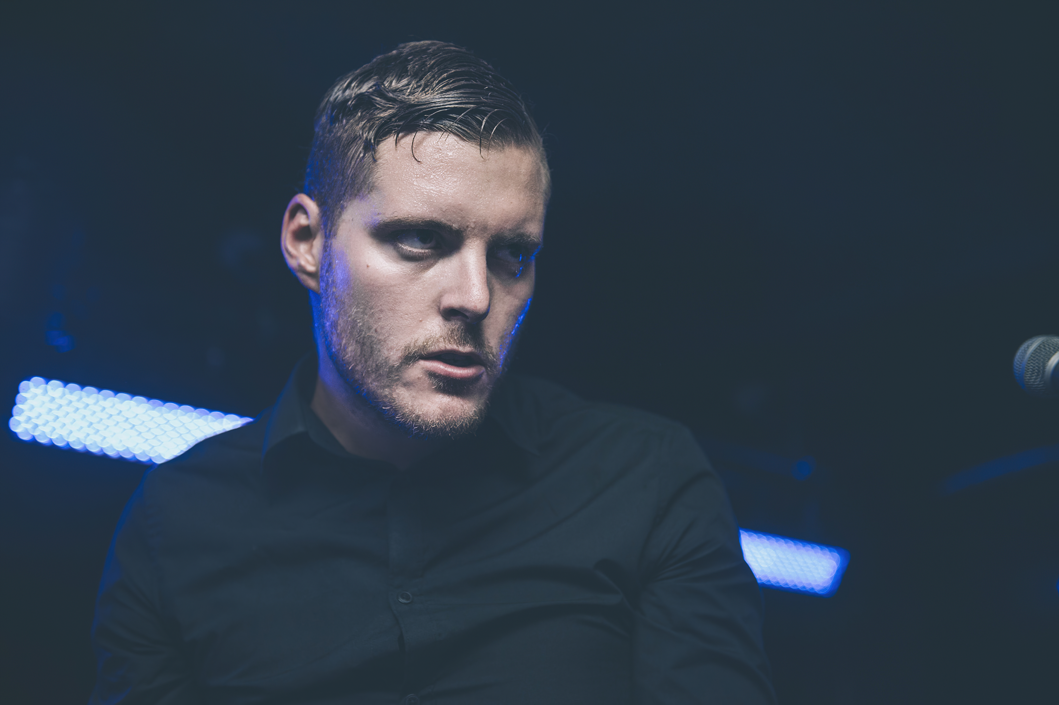 Deafheaven musician performing live under blue light HD Wallpaper