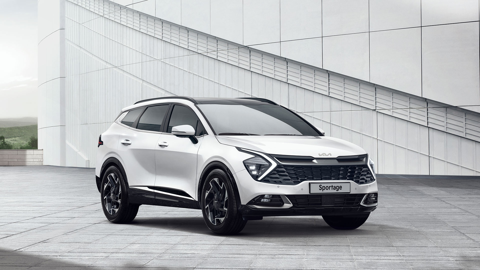 White Kia Sportage SUV in modern urban setting HD Wallpaper