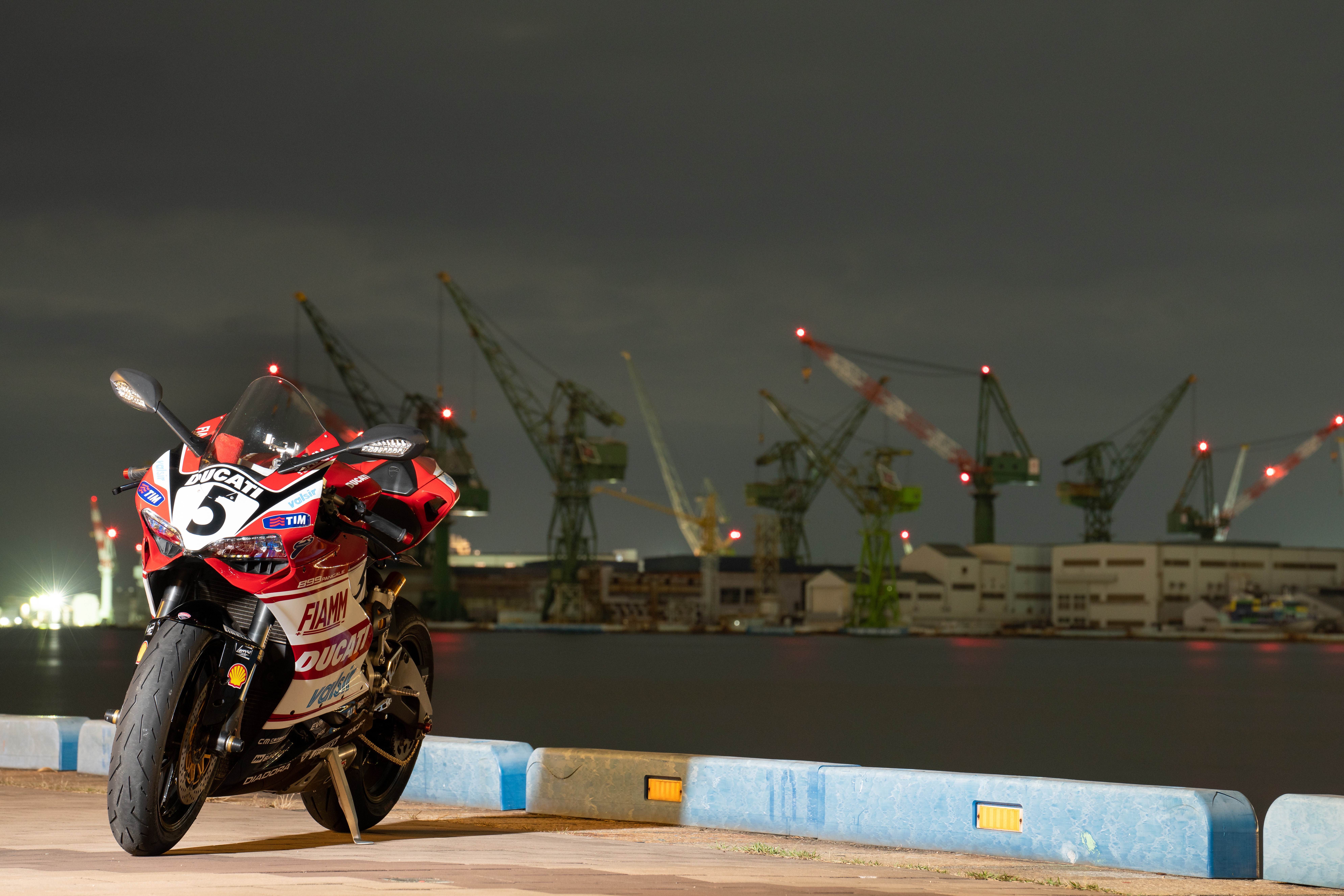 Red Ducati Panigale V4 at Night with Cranes HD Wallpaper