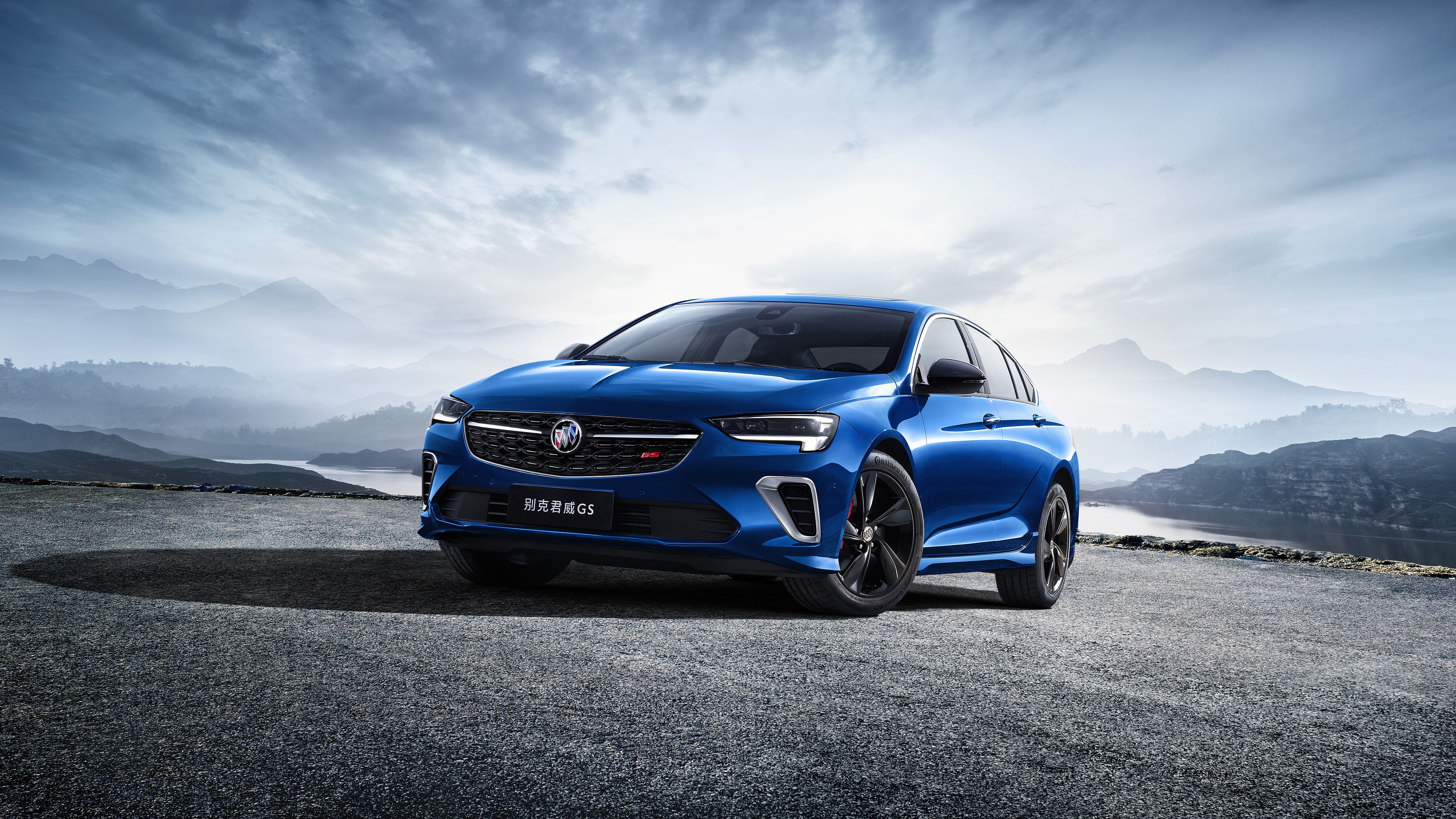 Blue Buick Regal GS 4K on a mountain road HD Wallpaper