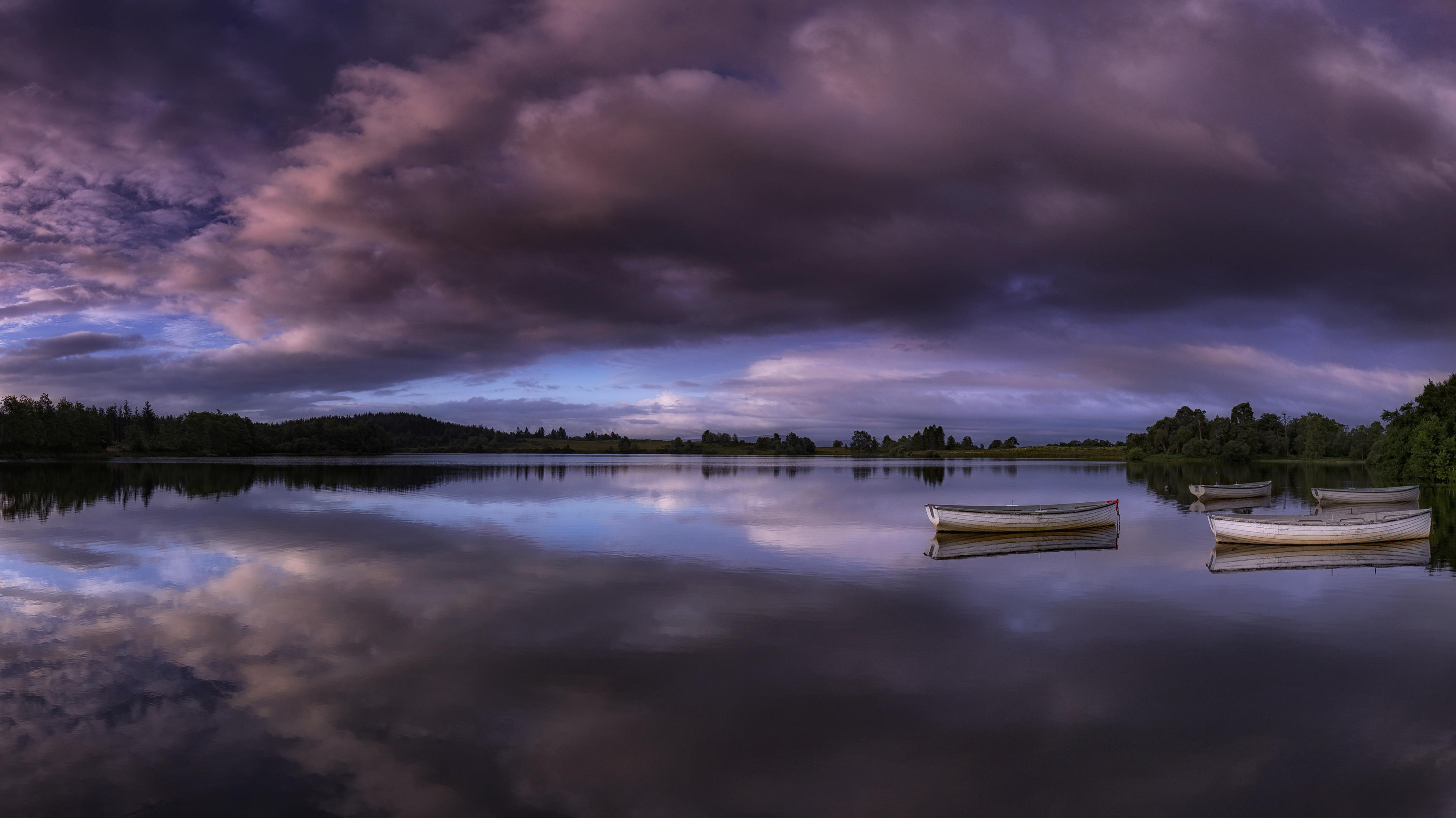 Dramatic Purple Sky Reflected in Lake with Boats HD Wallpaper