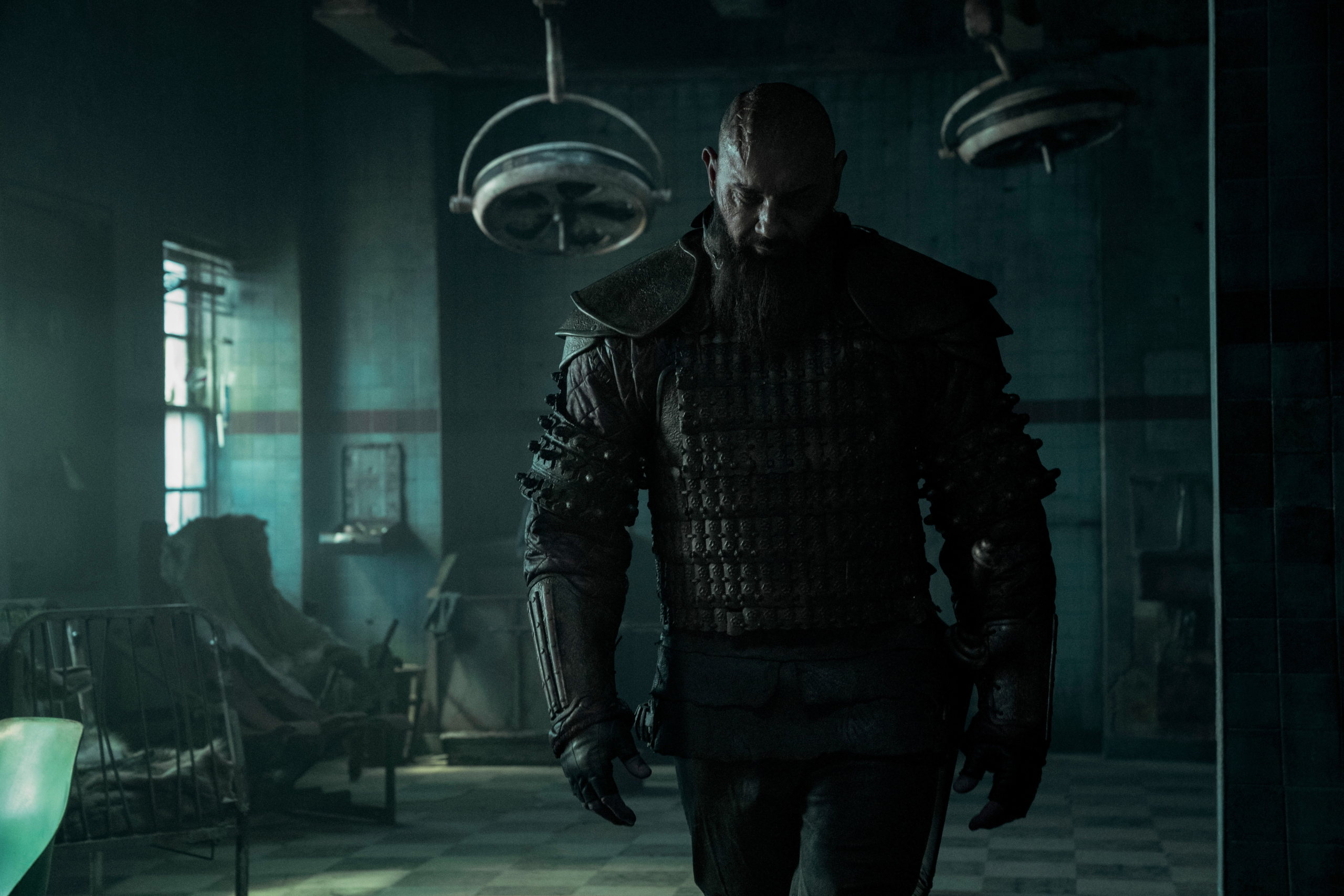 Dave Bautista in dark armor in an old hospital HD Wallpaper