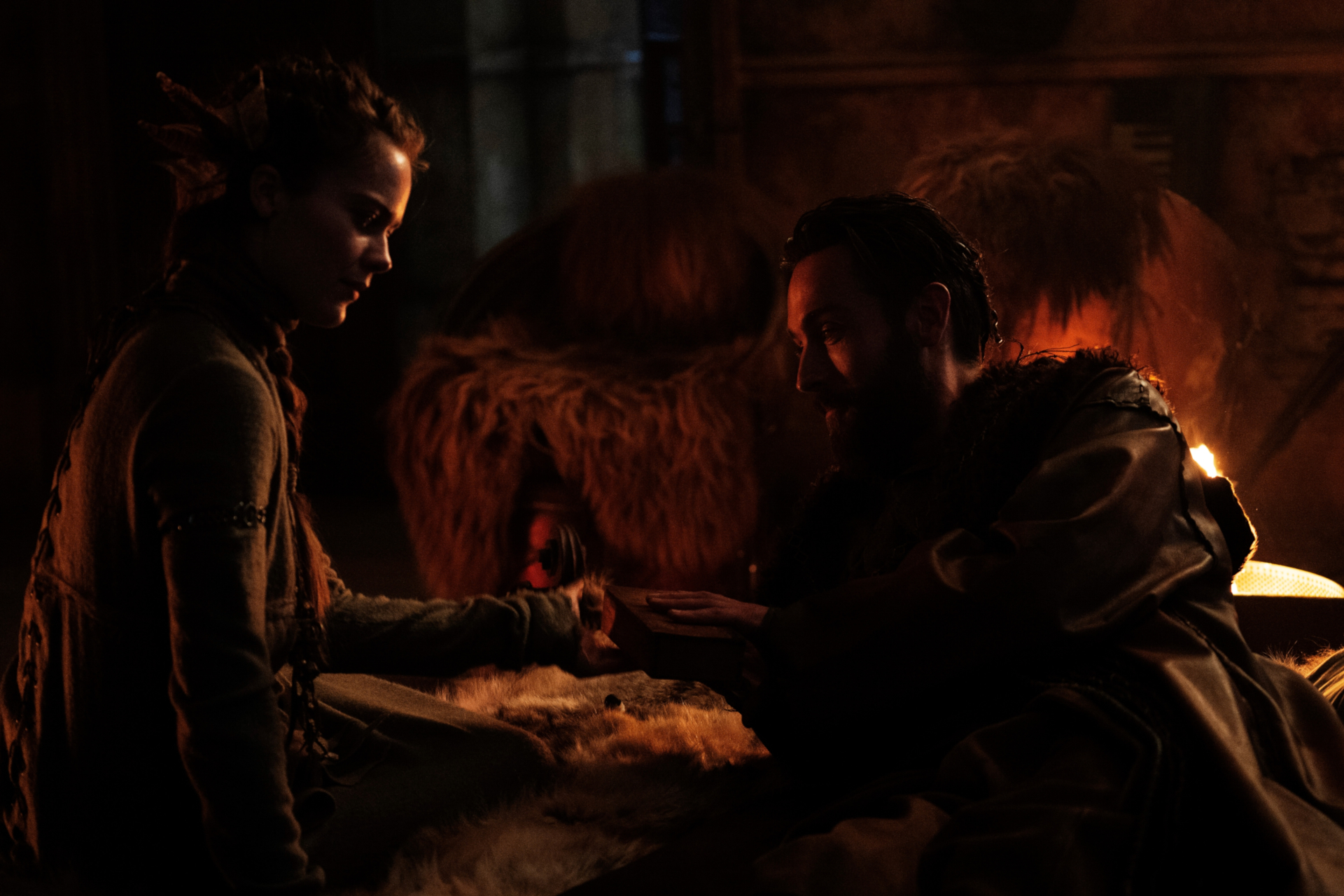 Hera Hilmar and Tom Mison sharing a moment by firelight HD Wallpaper
