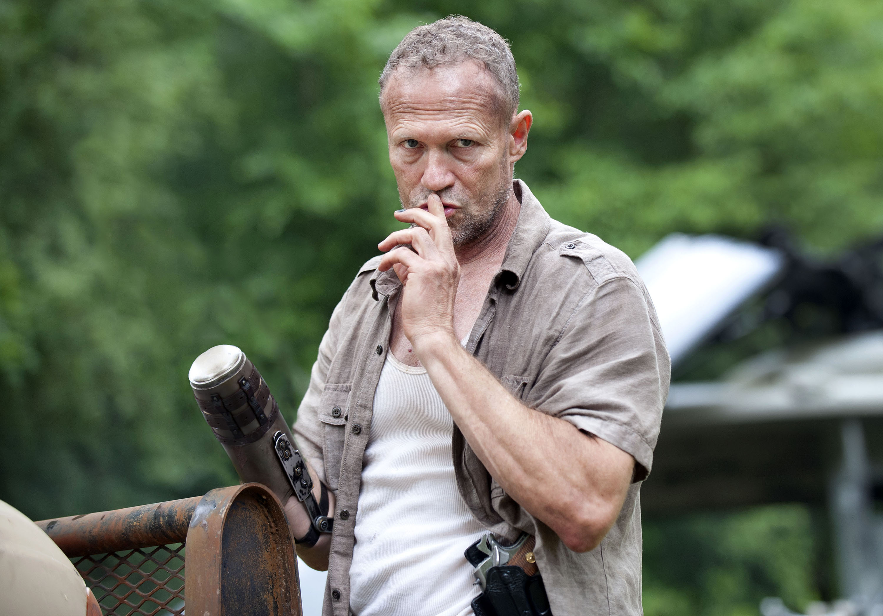 Merle Dixon with prosthetic arm and gun HD Wallpaper