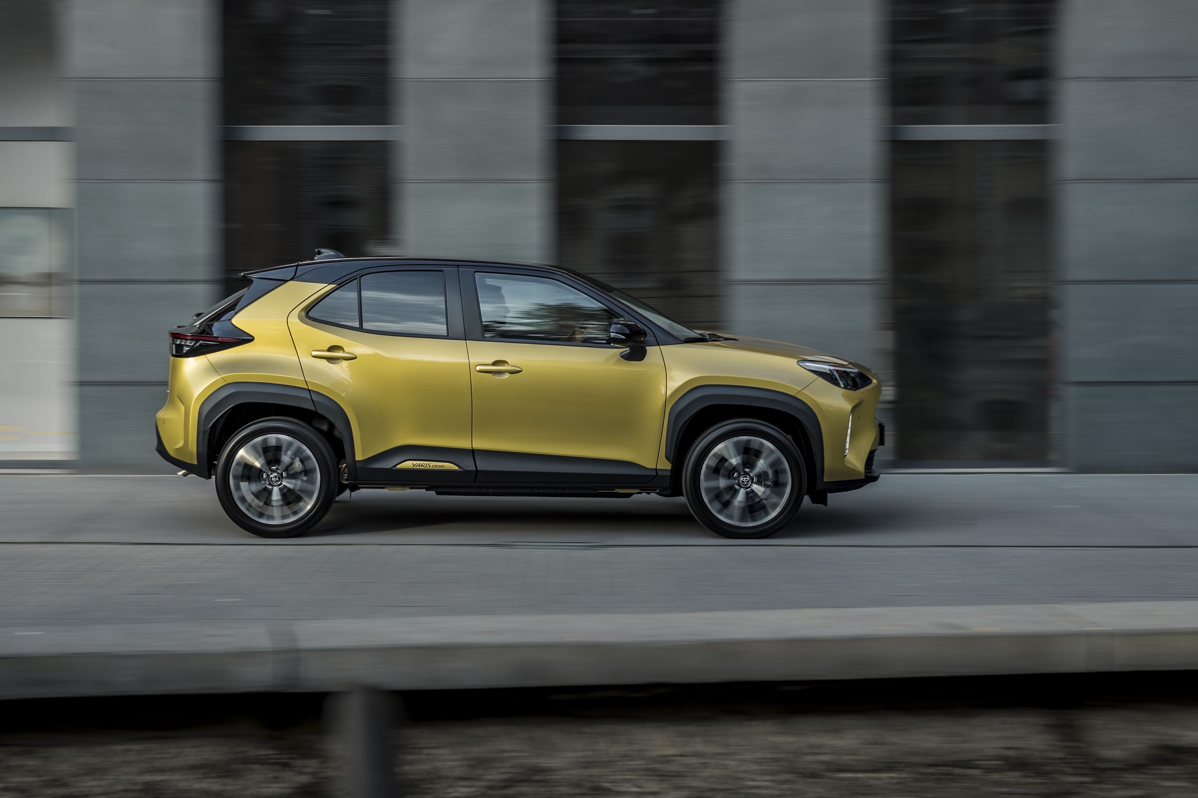 Elegant yellow Toyota Yaris Cross Hybrid SUV in motion HD Wallpaper