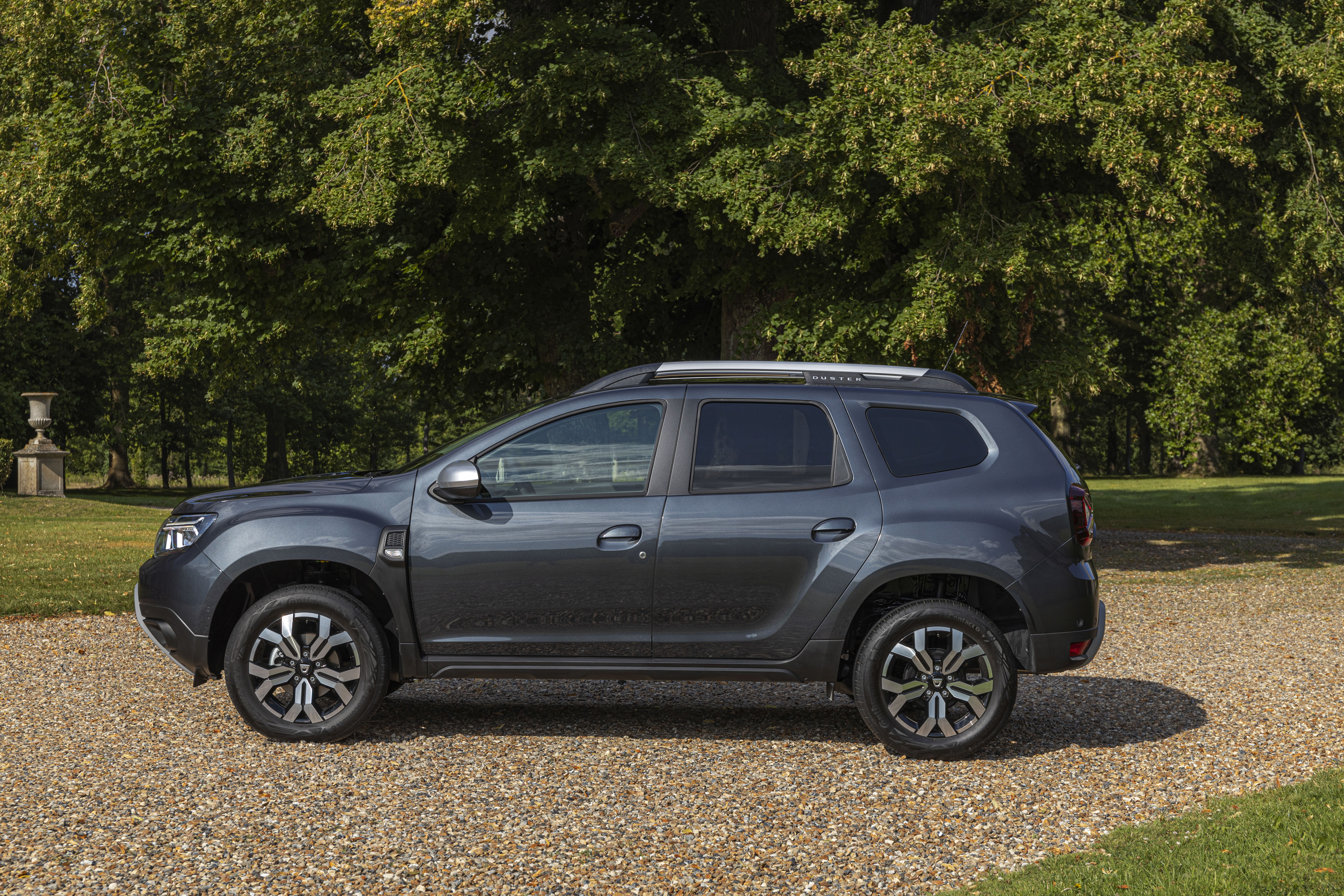 Grey Dacia Duster ECO SUV on gravel path HD Wallpaper