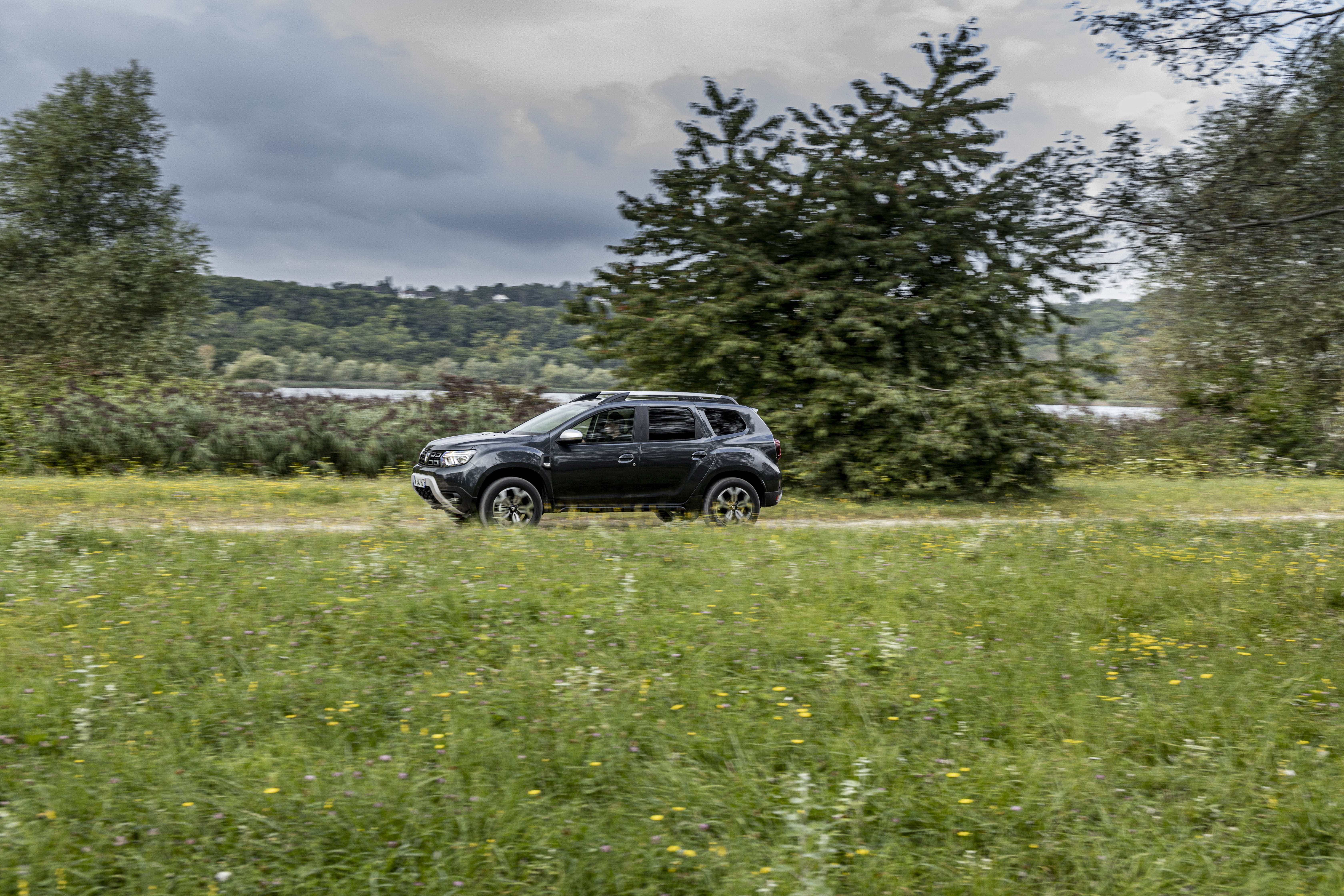 Dacia Duster ECO SUV driving in nature HD Wallpaper