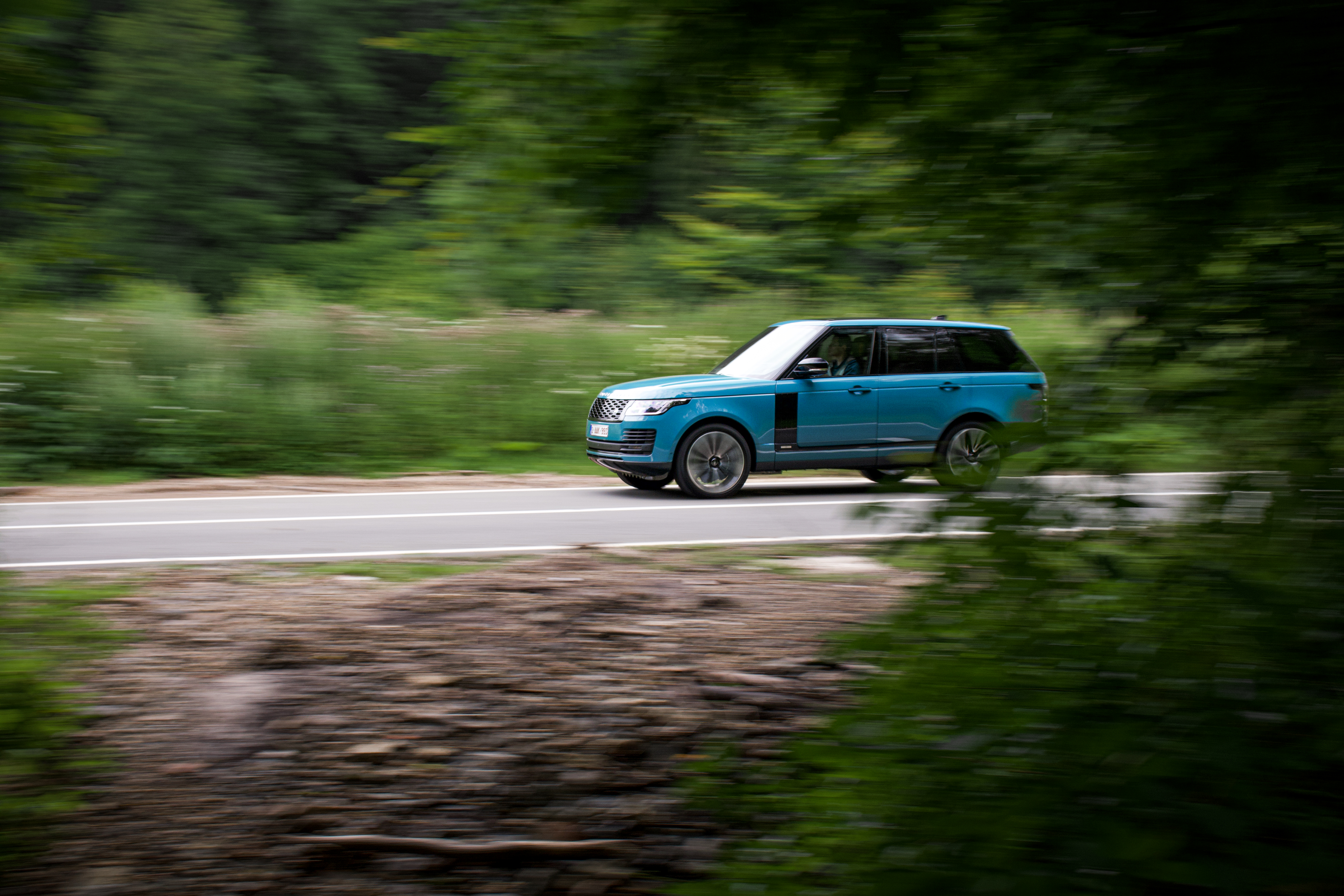 Blue Range Rover Autobiography "Fifty" SUV driving through forest HD Wallpaper