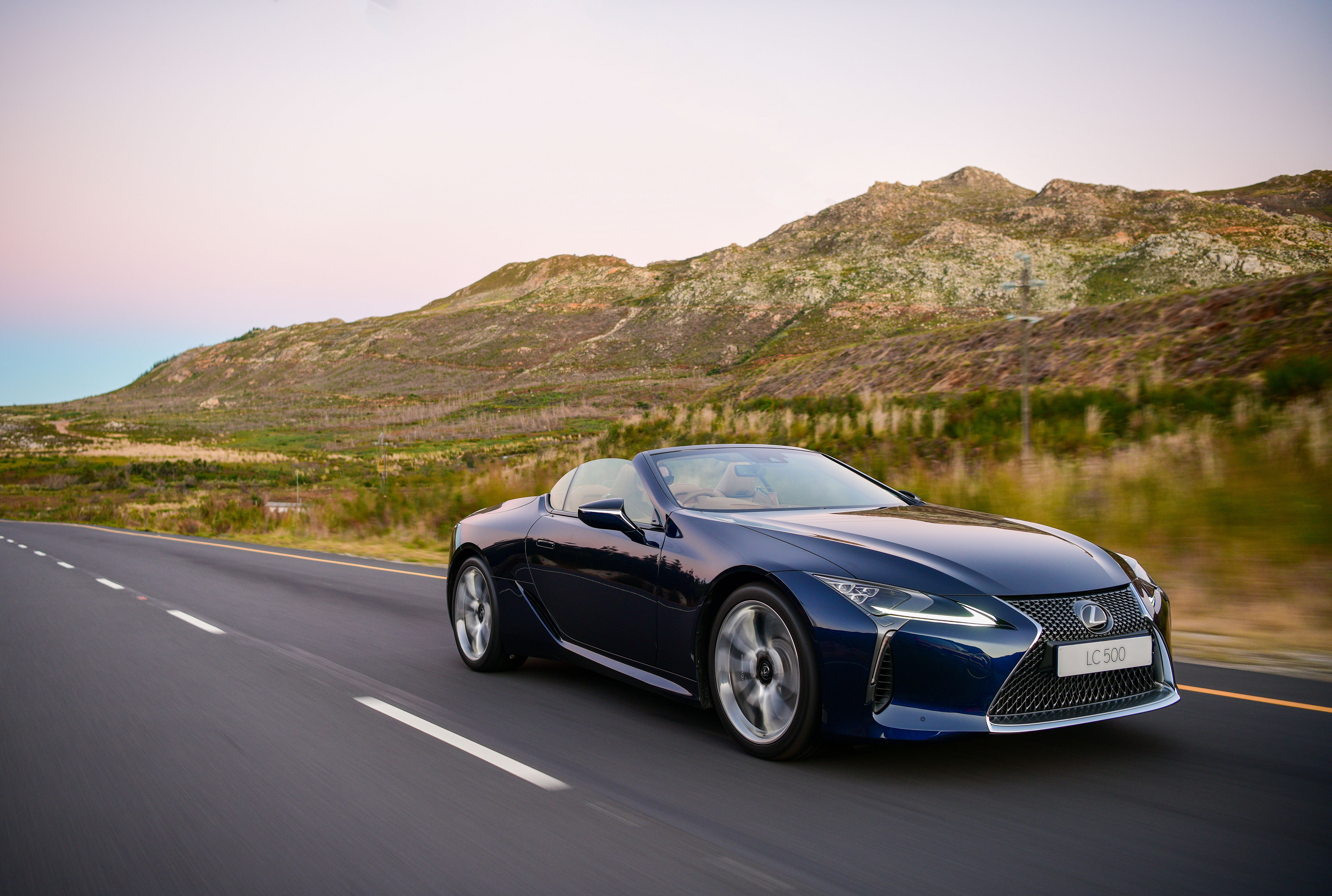 Lexus LC 500 Cabriolet driving on a scenic road HD Wallpaper