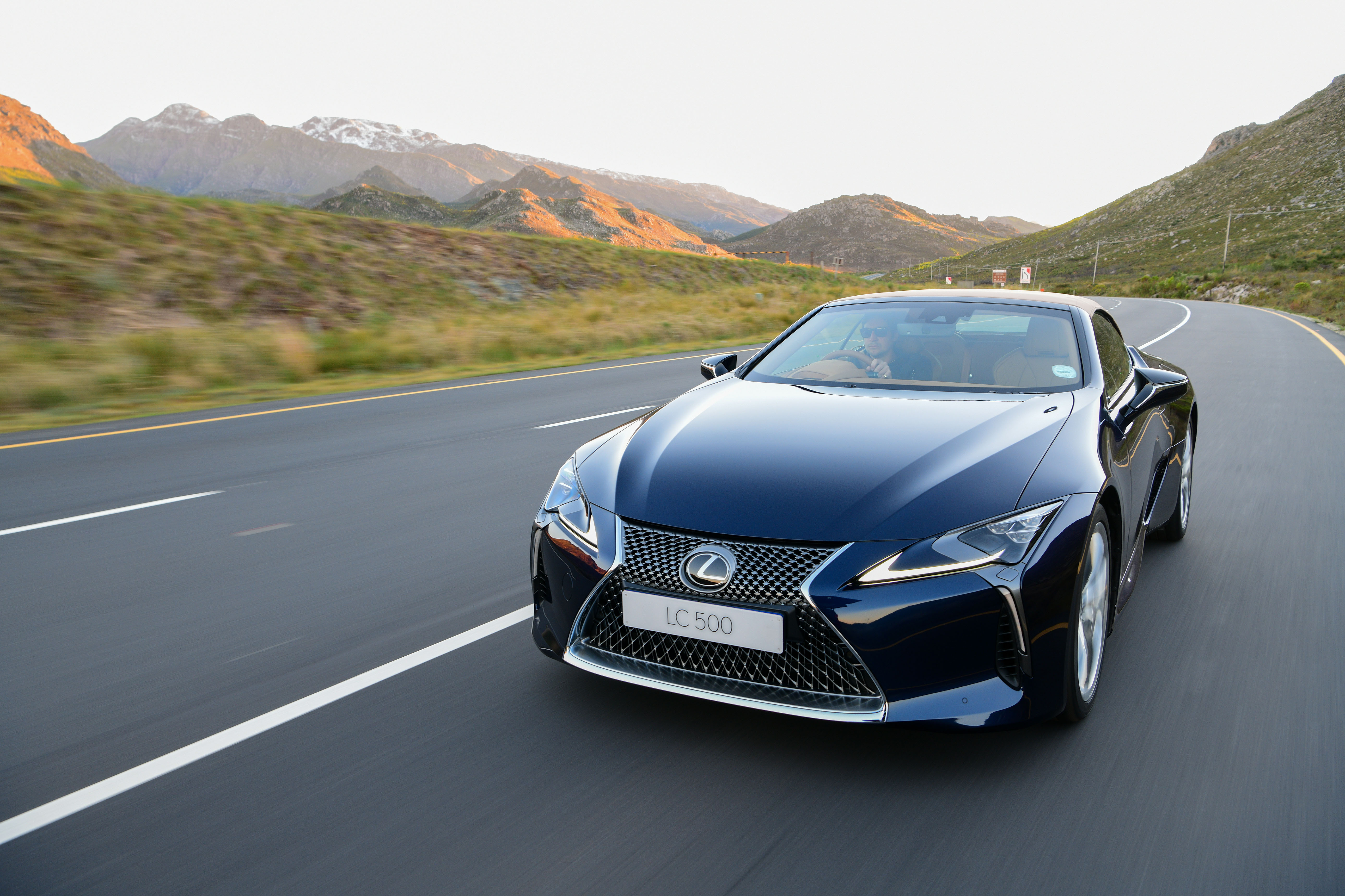 Lexus LC 500 Luxury Cabriolet on a scenic mountain road HD Wallpaper
