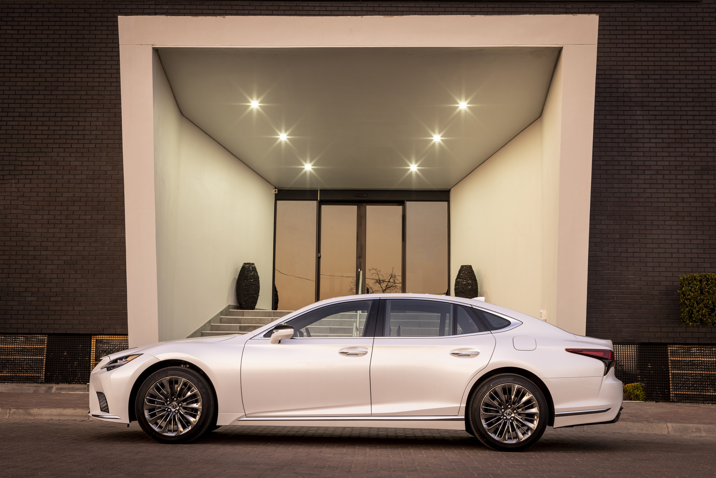 Elegant Lexus LS 500 luxury car at illuminated entrance HD Wallpaper