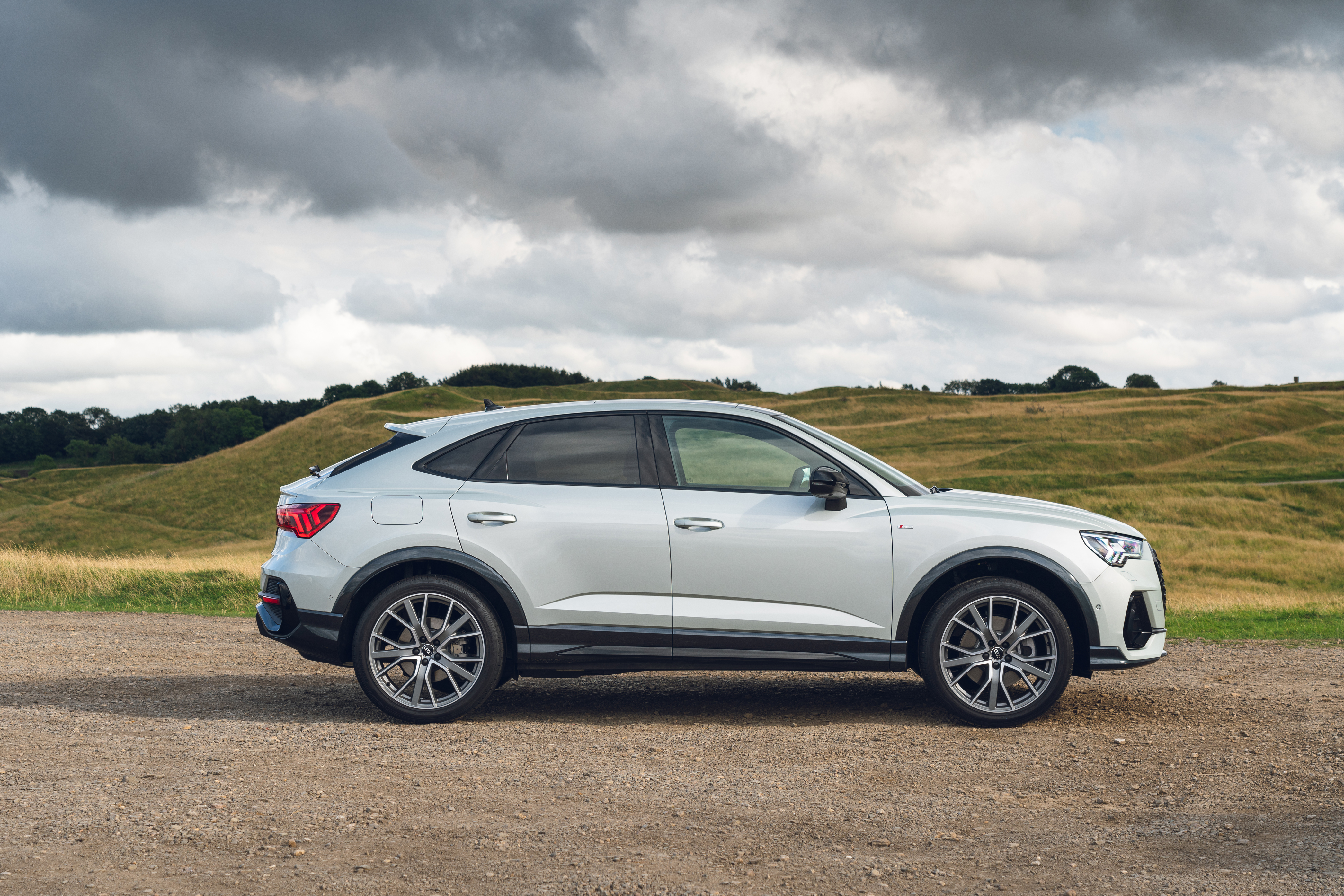 Audi Q3 Sportback S Line SUV on dirt road HD Wallpaper