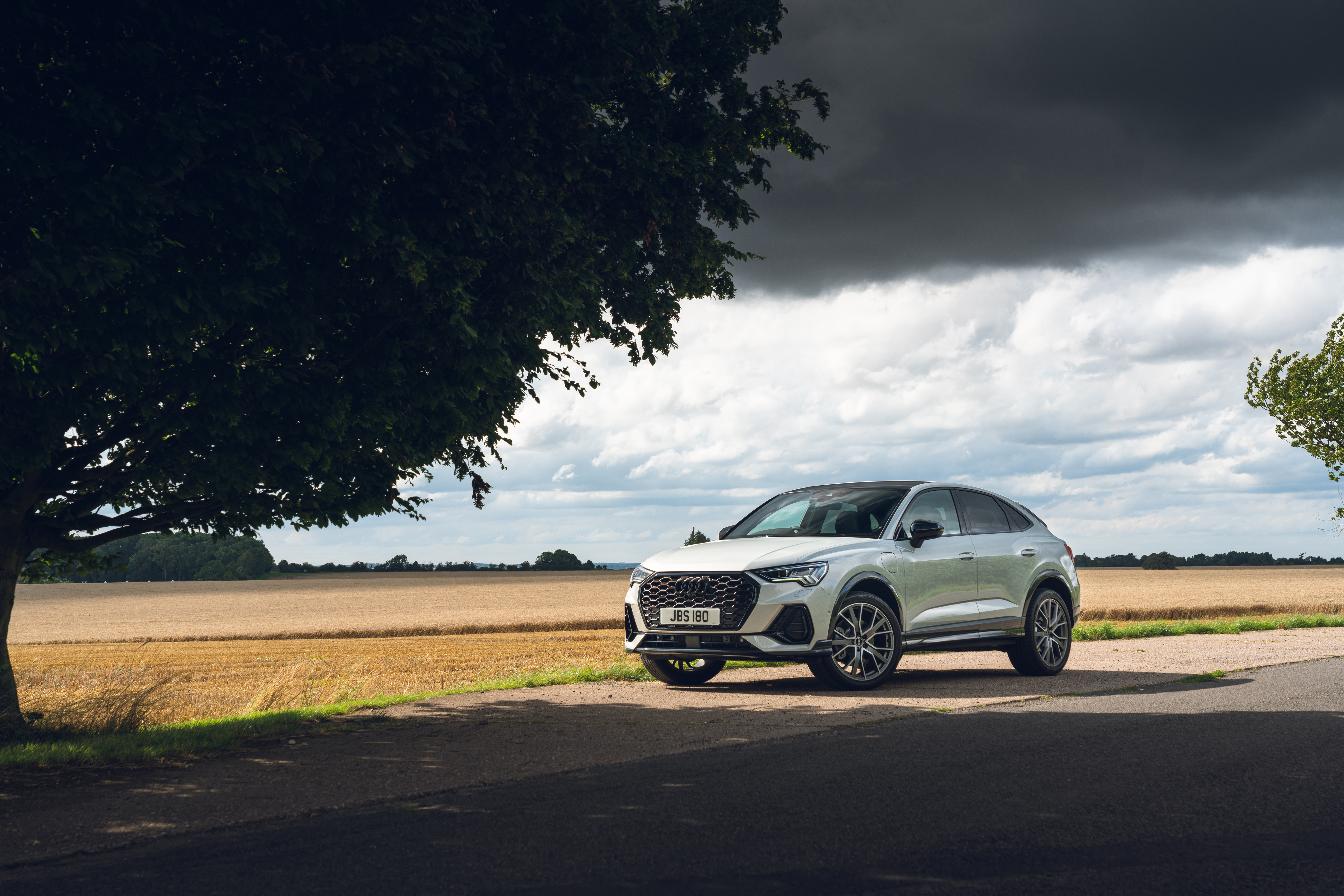 Audi Q3 Sportback SUV on a country road HD Wallpaper