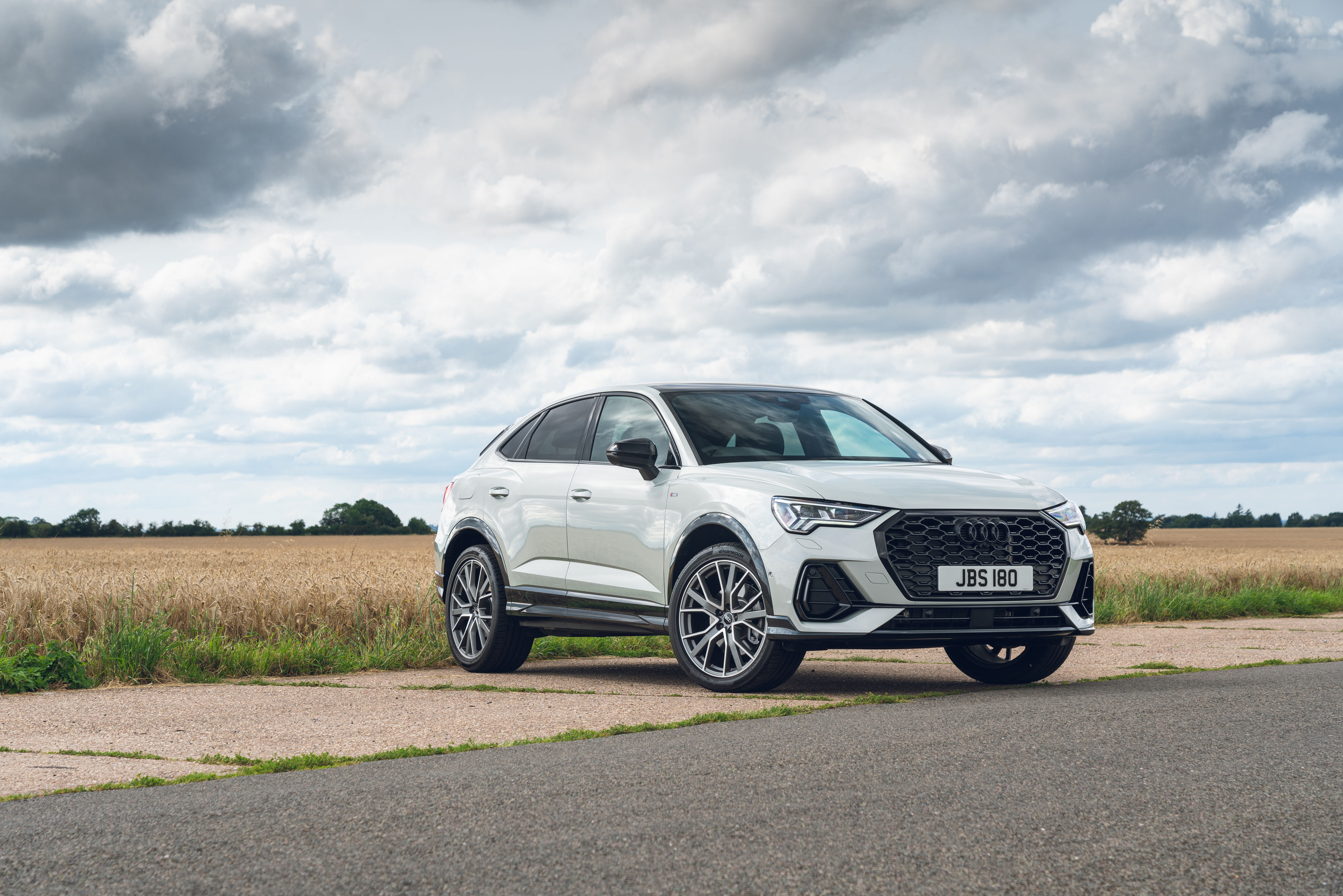 White Audi Q3 Sportback S Line SUV on a rural road HD Wallpaper