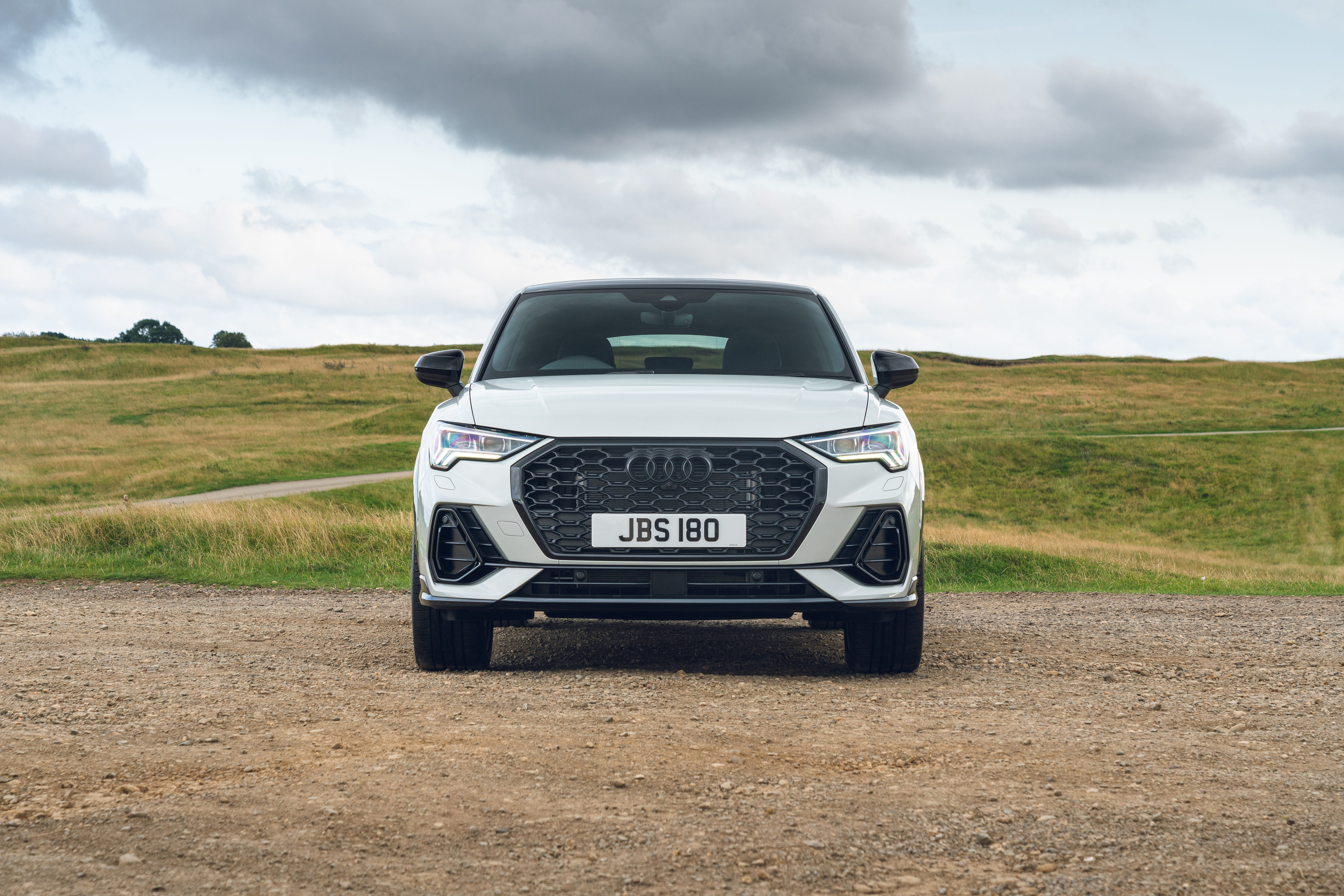 Audi Q3 Sportback S Line SUV on a dirt road HD Wallpaper