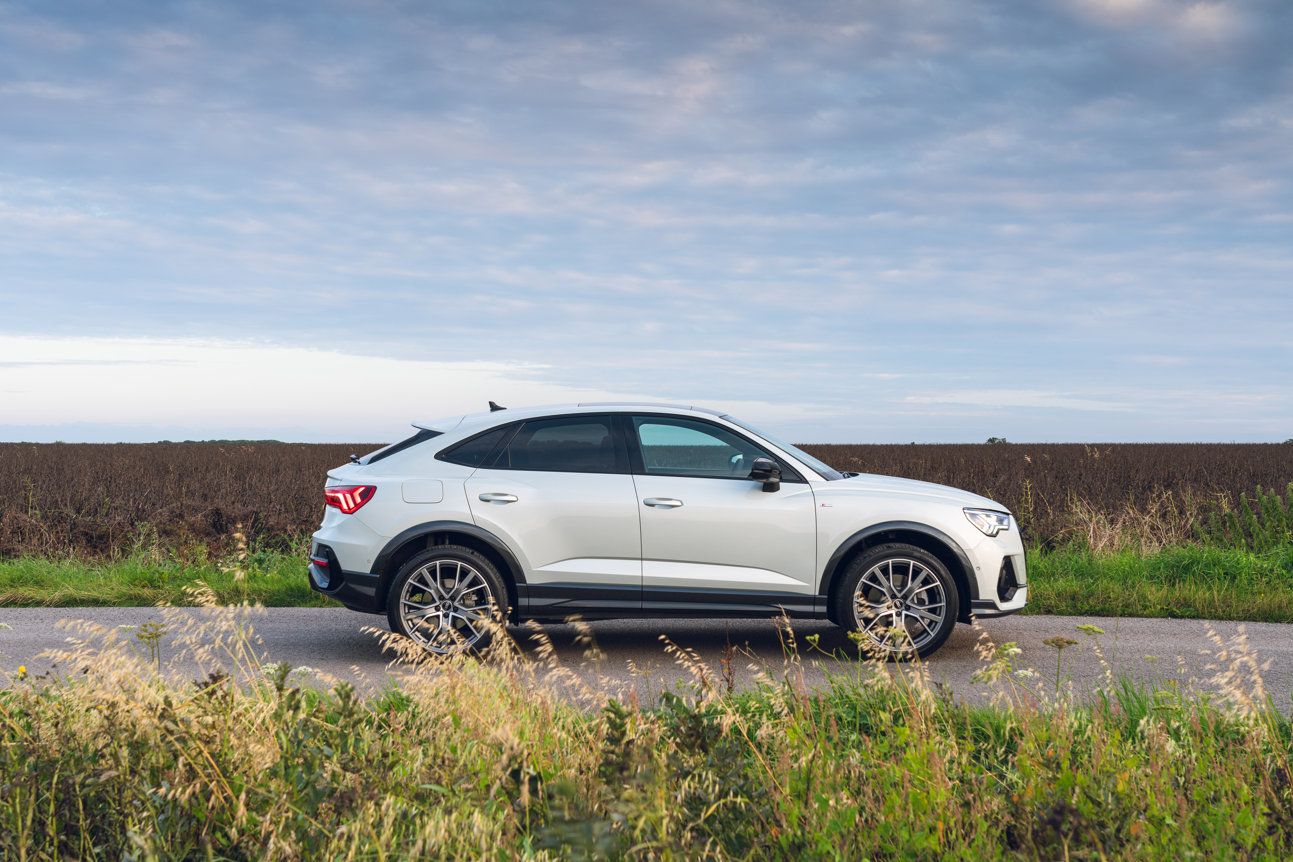 Audi Q3 Sportback S Line SUV on country road HD Wallpaper