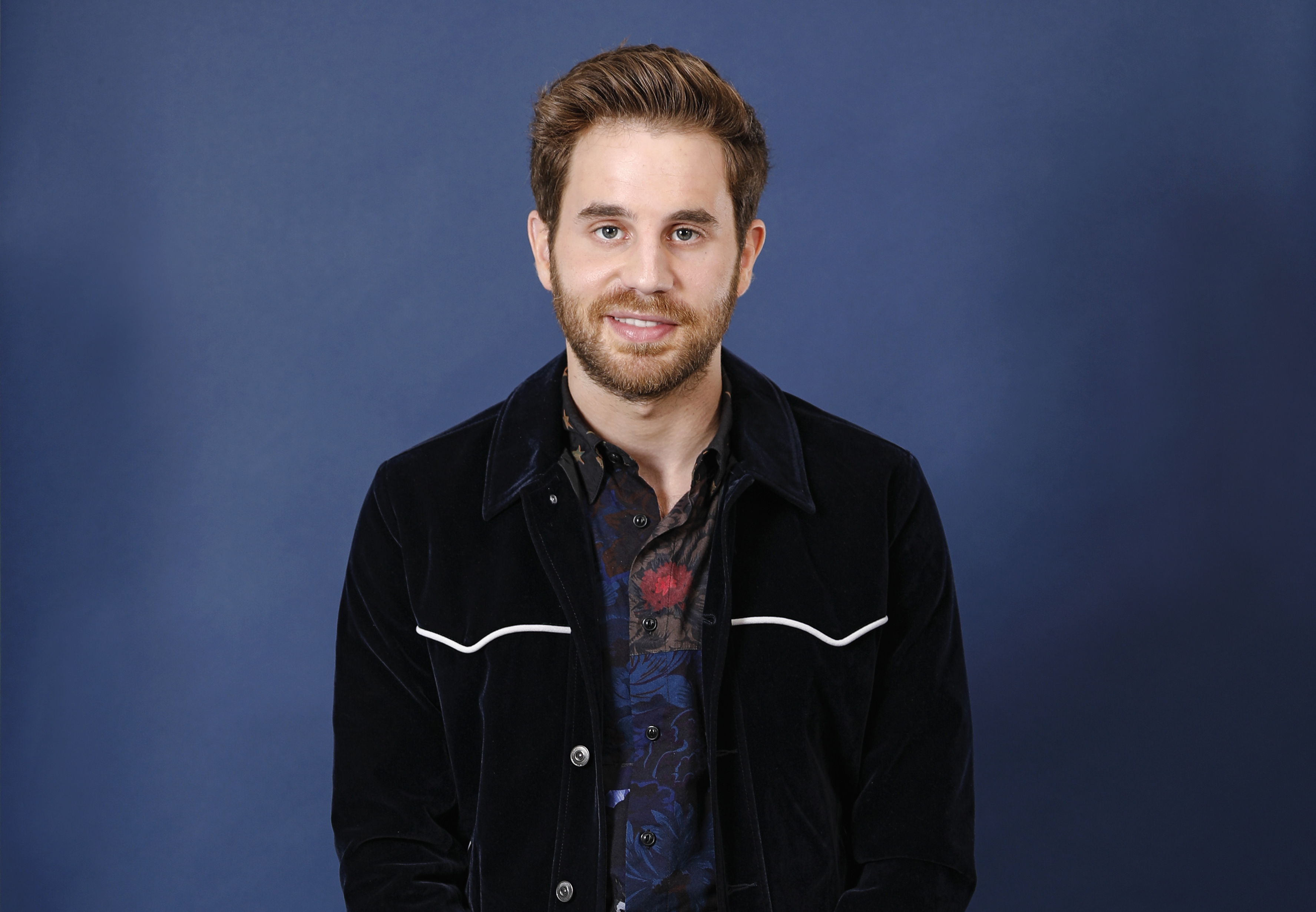 Ben Platt smiling in a dark velvet jacket HD Wallpaper