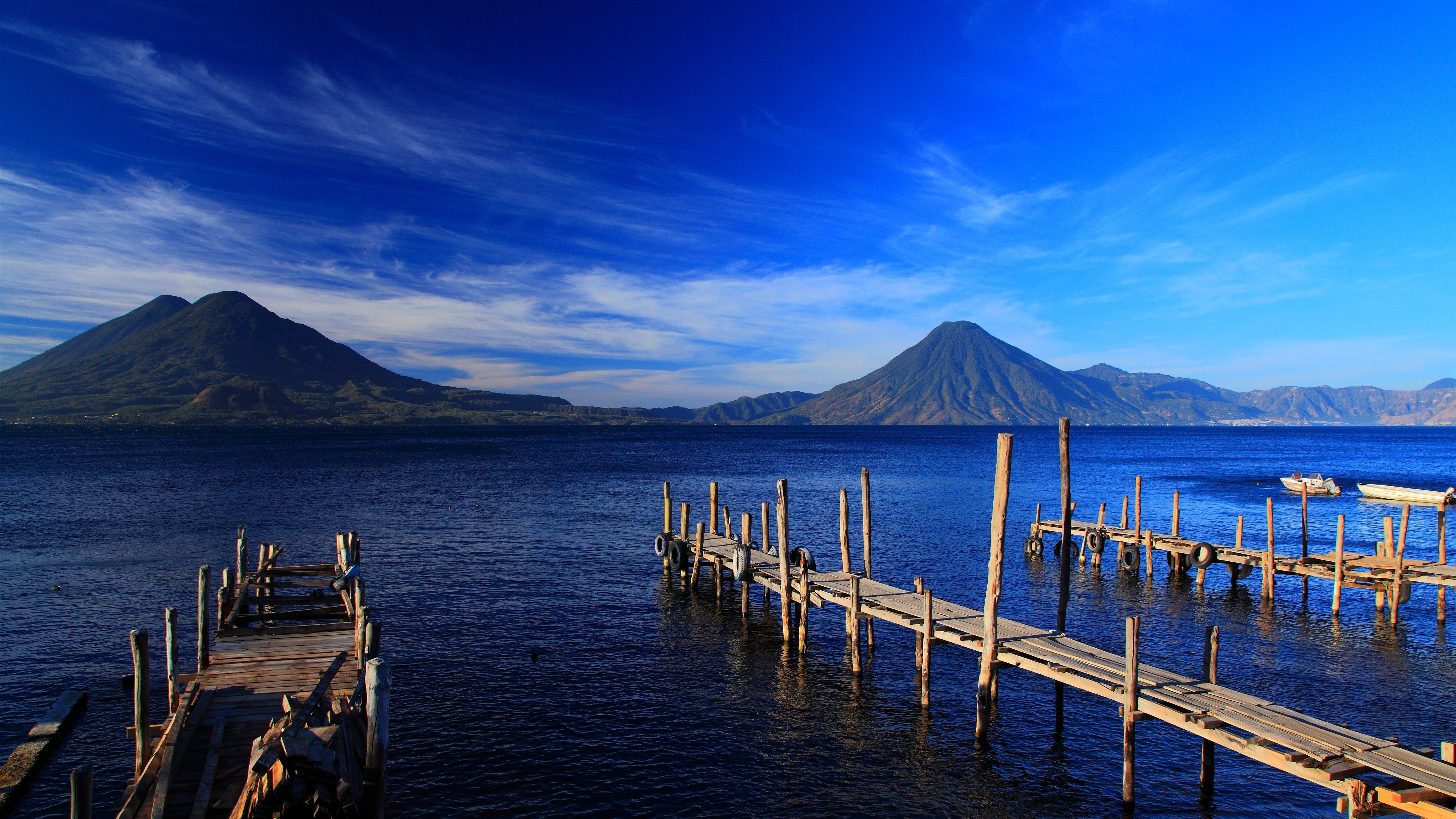 Vibrant Blue Lake, Mountains, and Piers 4K HD Wallpaper