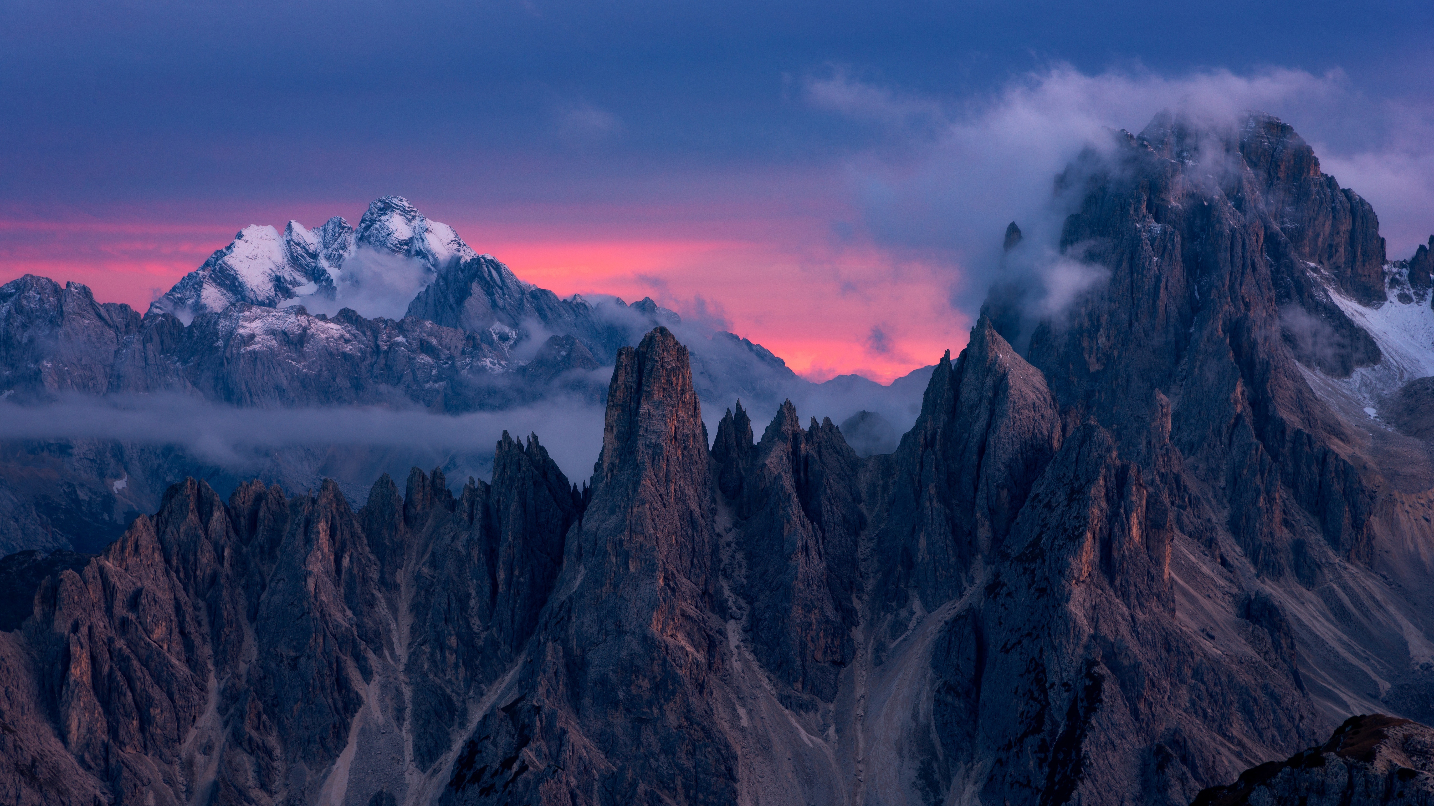 Rugged mountain peaks under a colorful twilight sky HD Wallpaper